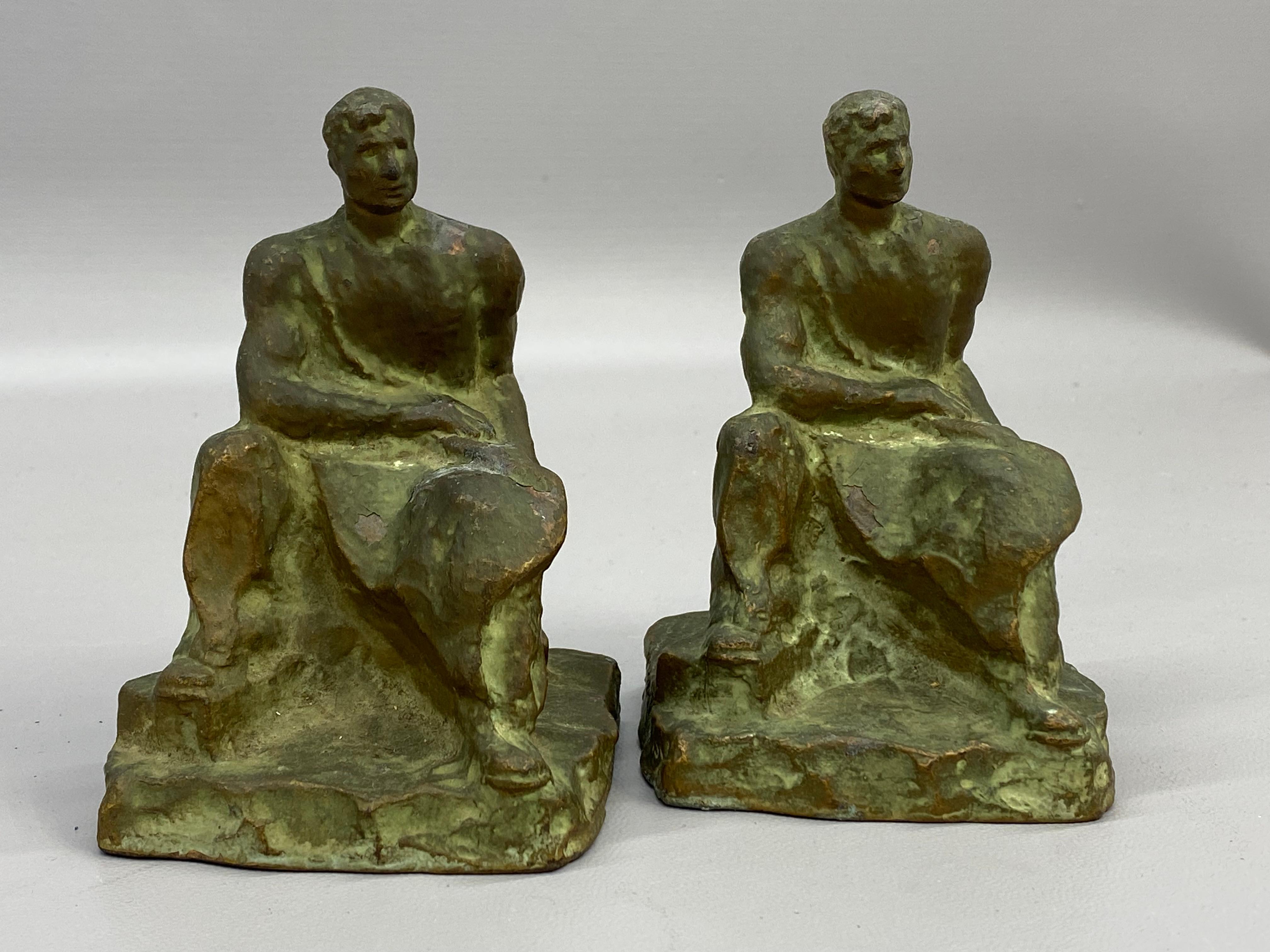 A fine pair of McClelland Barclay (1891-1943) designed bronzed bookends, circa 1920-30. The seated figures look to be wearing a long durable apron with each supporting a hammer in the left hand leaning on a rock or anvil. Most likely a blacksmith or