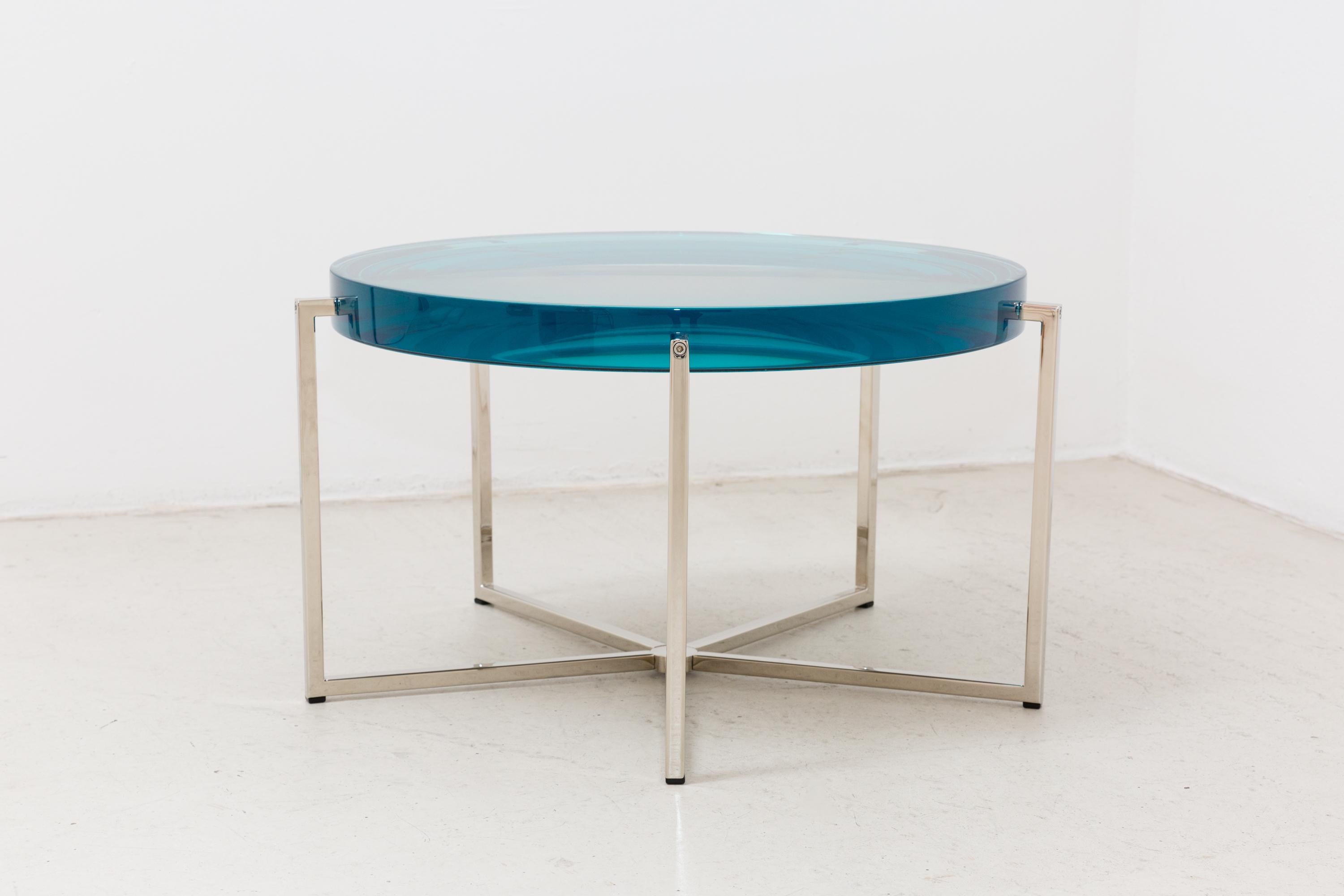 McCollin Bryan Lens table ins turquoise. Resin top backed by acrylic mirror on nickel base with five legs.