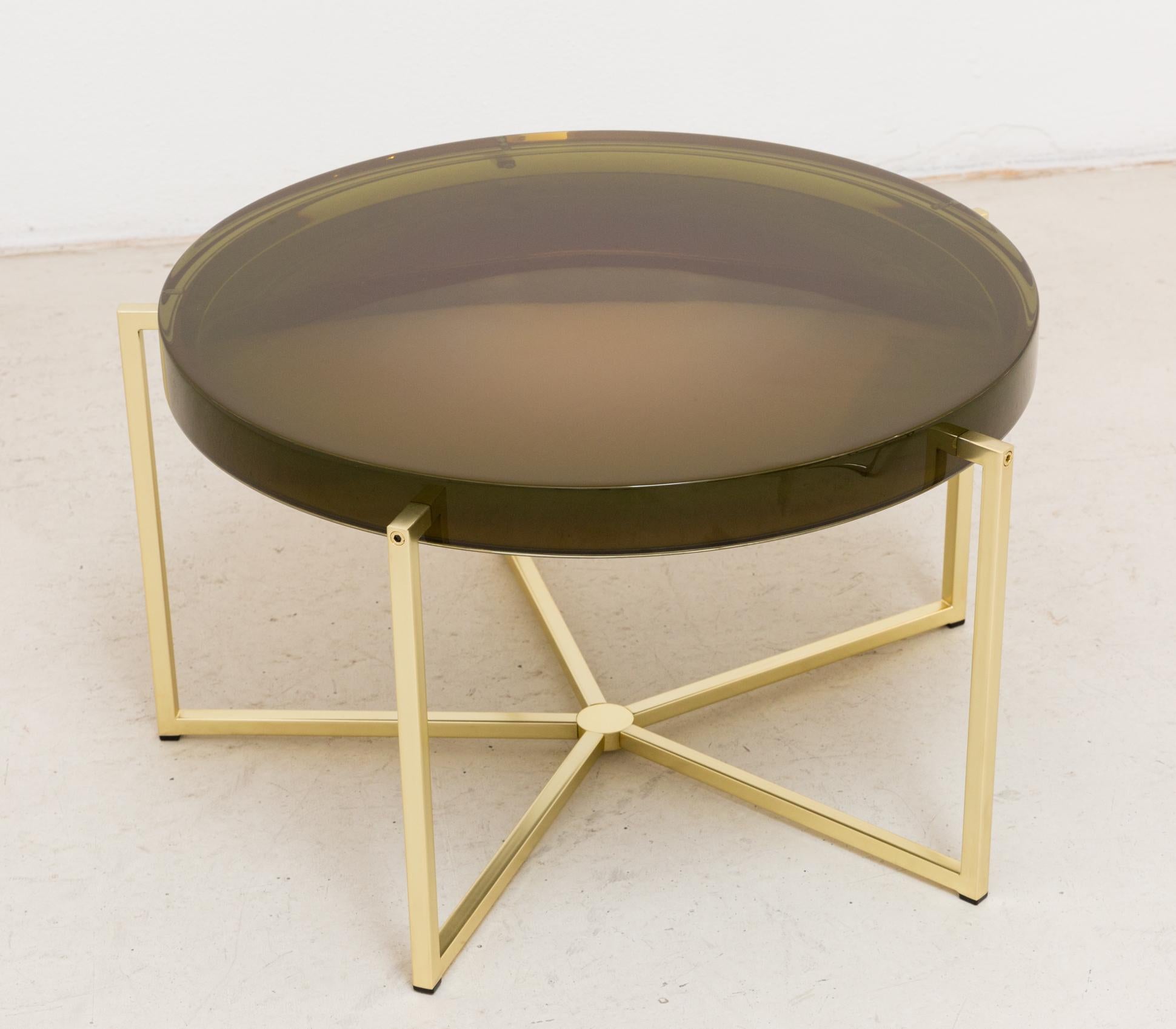 McCollin Bryan Lens table in bottle green. Resin top backed by acrylic mirror on brass base with five legs.