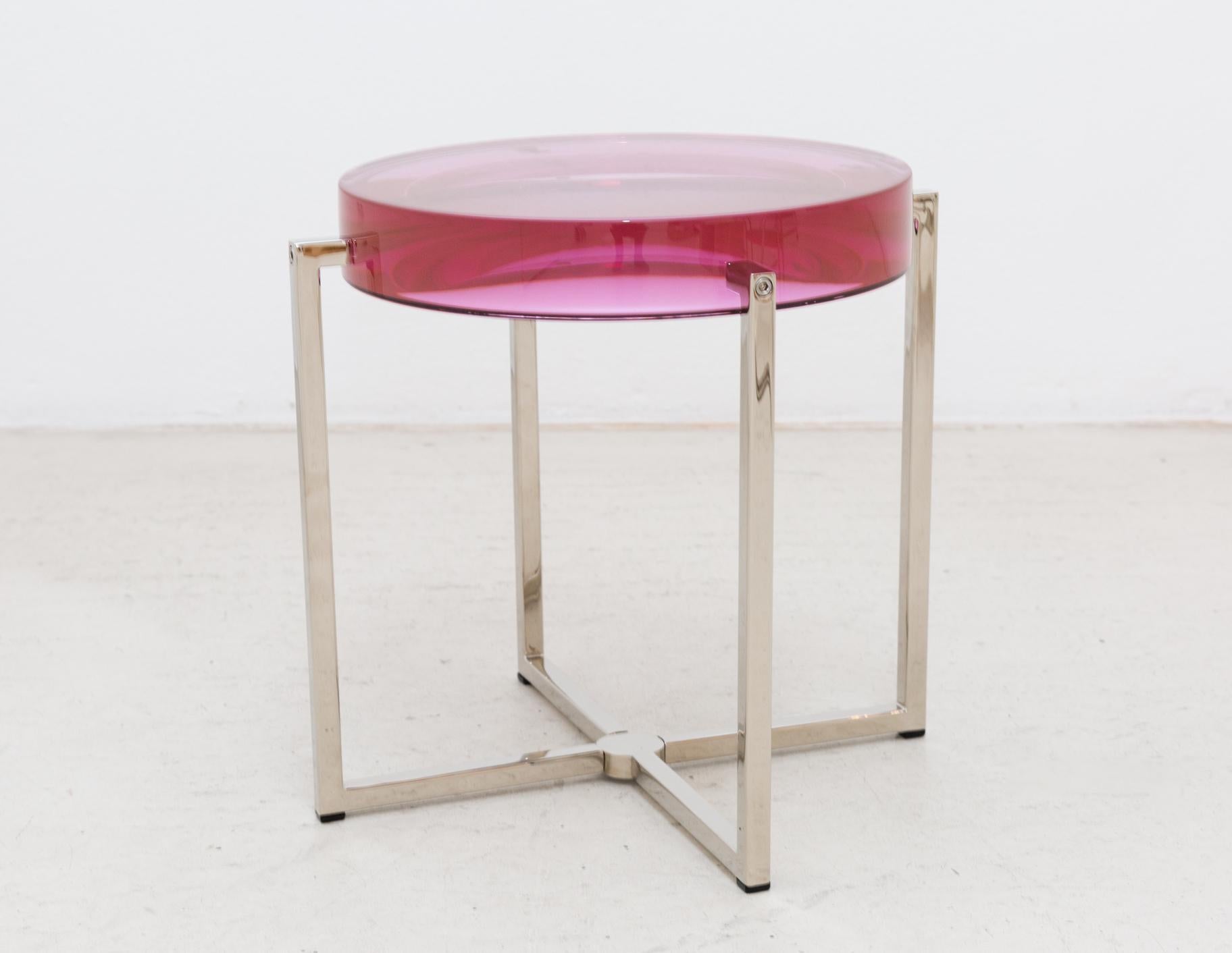 McCollin Bryan Lens table in bubble-gum pink. Resin top backed by acrylic mirror on nickel base with four legs.