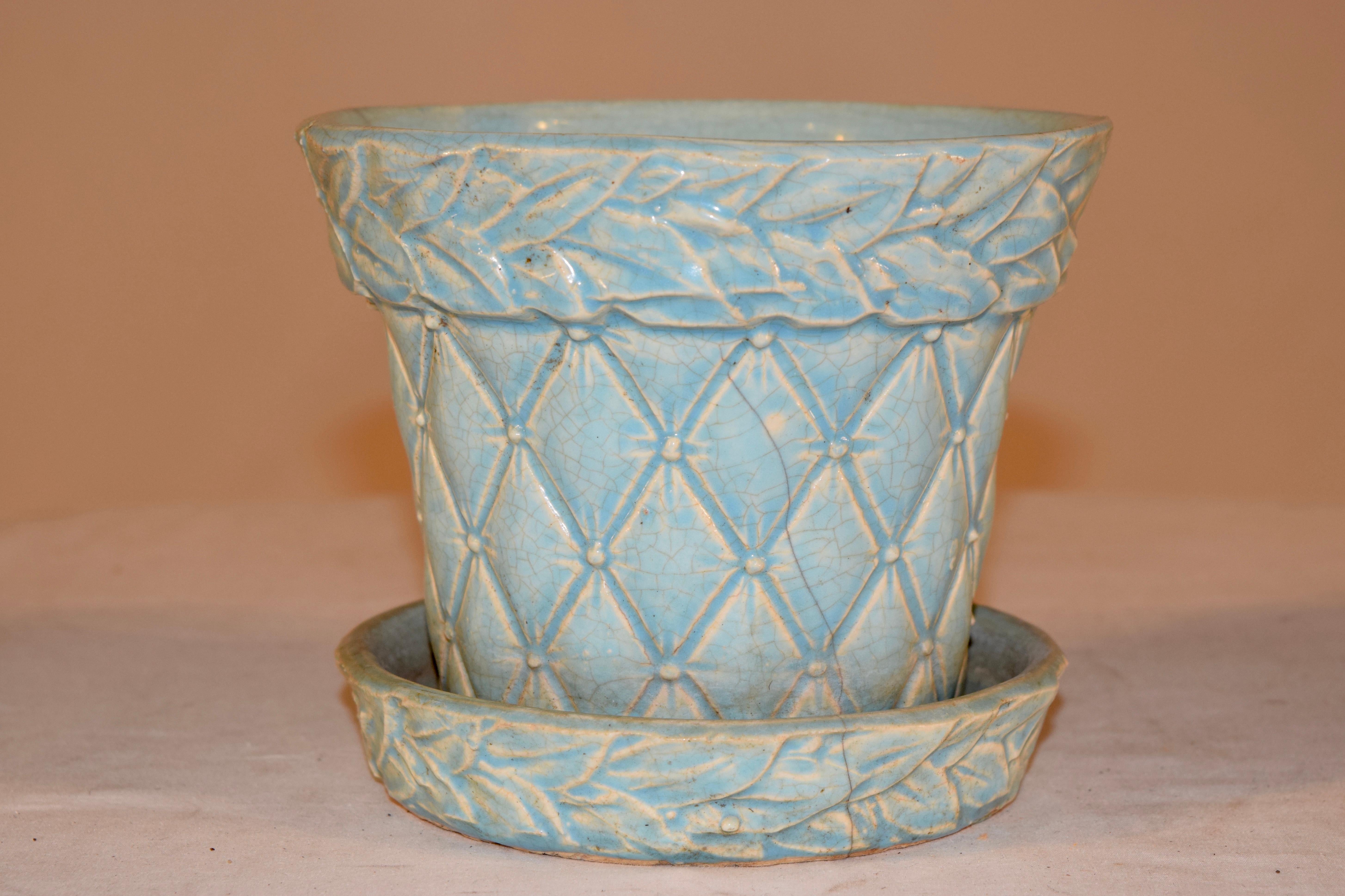 Midcentury McCoy turquoise pottery planter pot of quilted design with carved leaf detail. The saucer is attached and has a drainage hole. A great example of American art pottery.