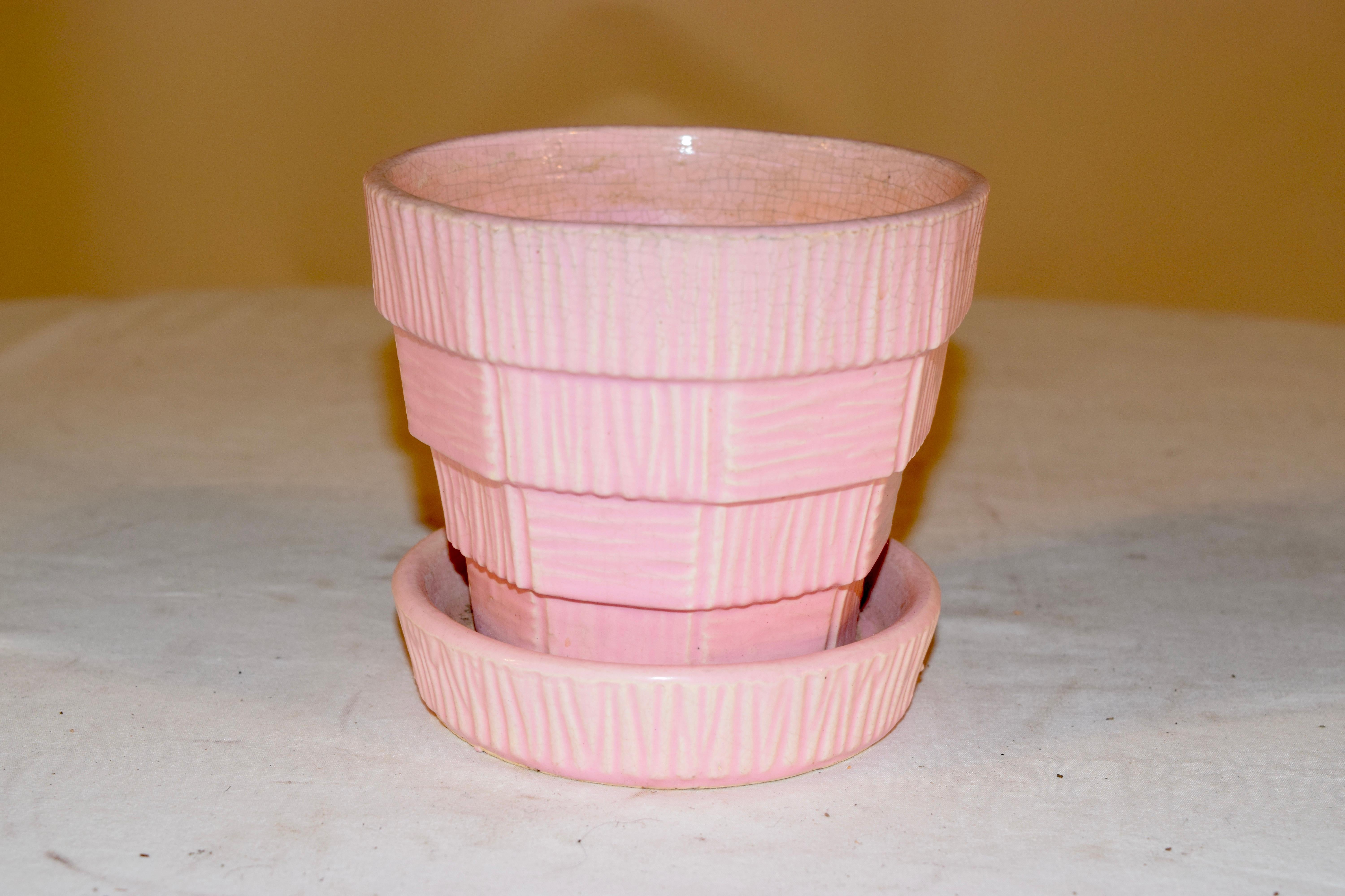 Midcentury McCoy pink flower pot with attached saucer, which also has a water drain built in. Nicely patterned and tiered pattern.