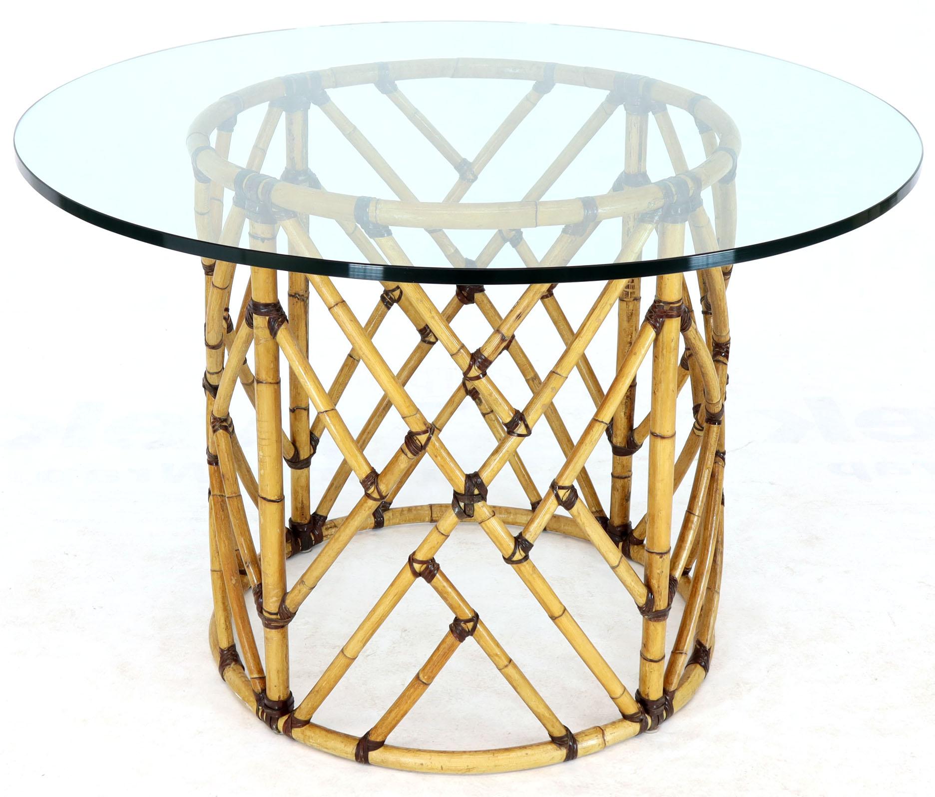 Mid-Century Modern round glass top dining table six chairs bamboo dining se by McGuire. Outstanding craftsmanship all bamboo parts are bonded with two different kinds of real leather. Pictured with 48