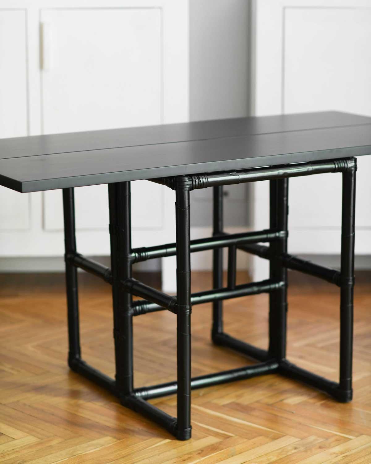 Late 20th Century Mcguire 70s console with opening shelf in black lacquered rattan