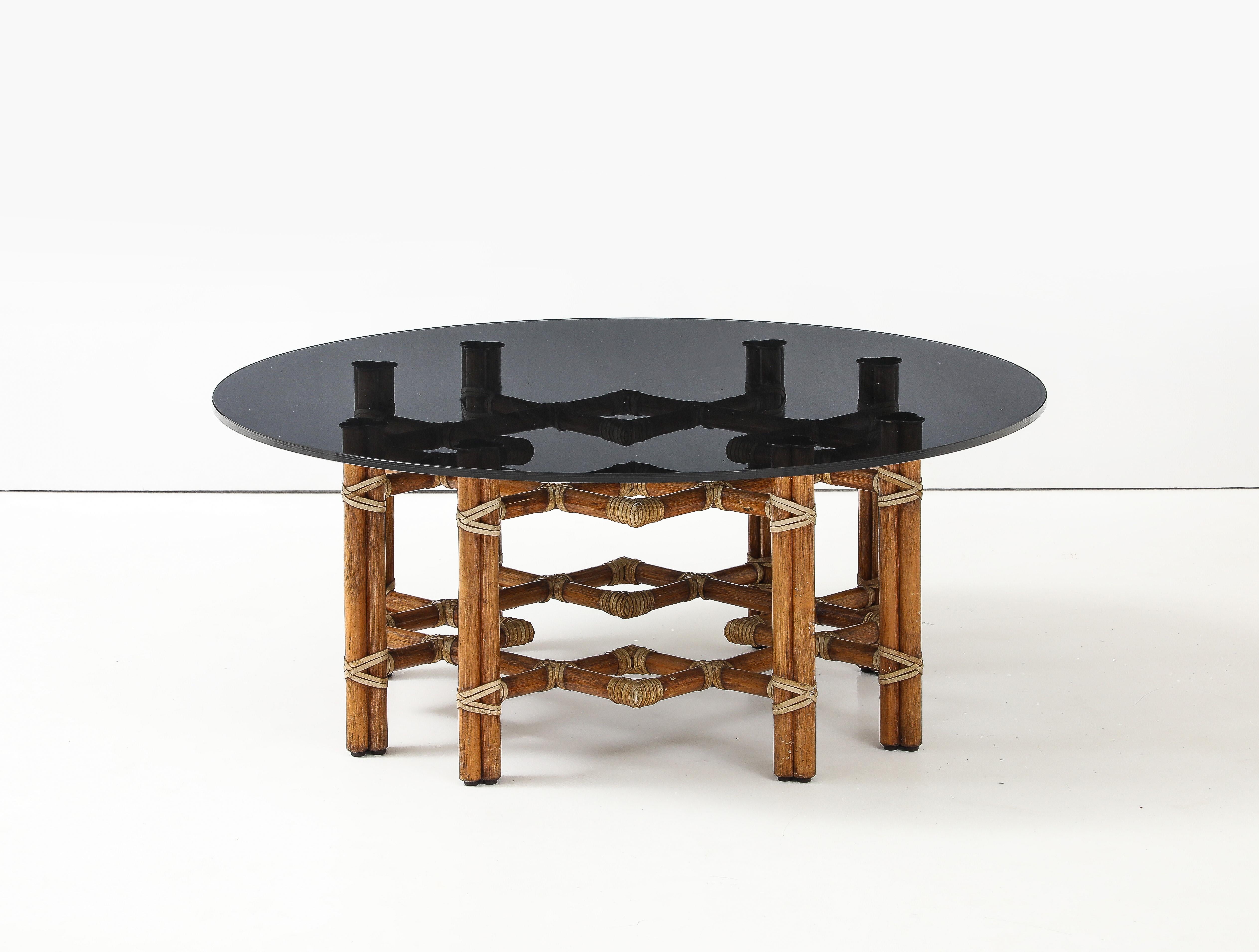 1970s McGuire of San Francisco Rattan and Bamboo Coffee Table
An iconic piece by McGuire of San Francisco, this coffee or cocktail table features an intricate double-square (octagonal) base design crafted from bamboo and rattan. The intersecting