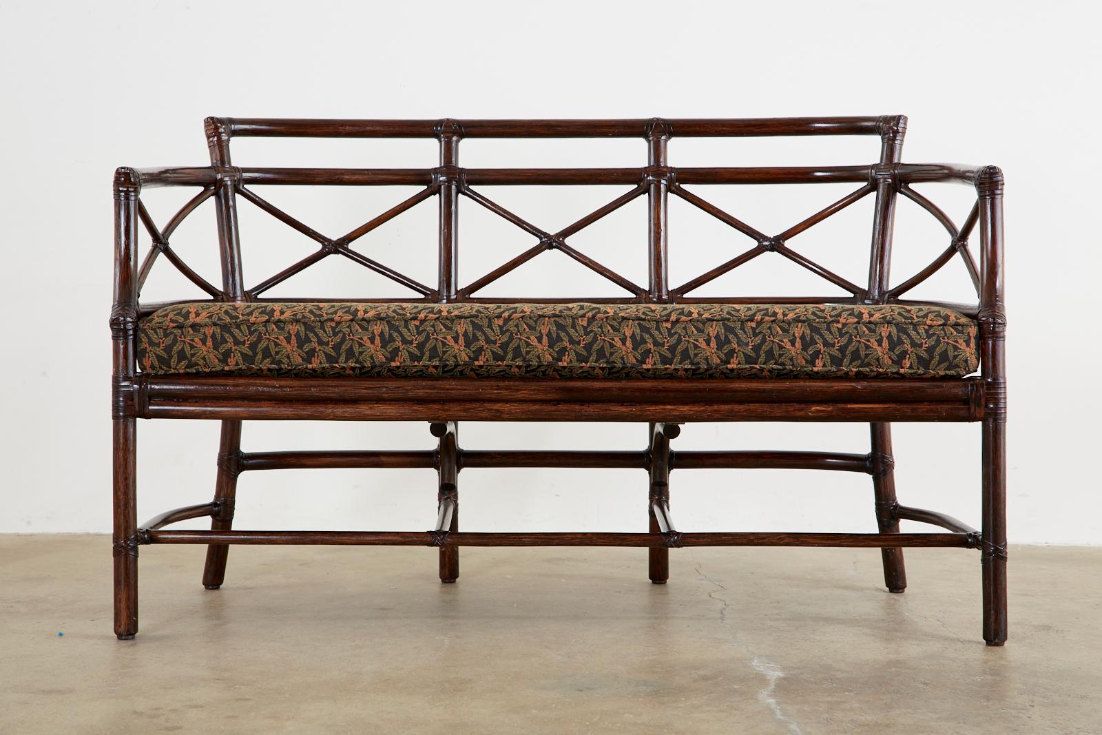 Genuine McGuire organic modern Gondola settee or bench crafted from bamboo rattan poles by McGuire. Designed by Elinor McGuire and inspired by Venetian gondolas in Italy. The frame has gracefully curved ends with X motifs in the back. The exposed