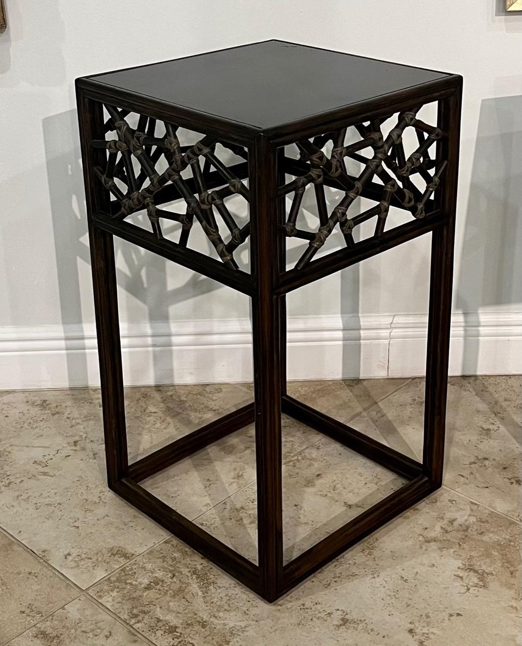Great looking contemporary McGuire side table. Bamboo and rattan with black glass top. Marked on bottom with a plaque.
 