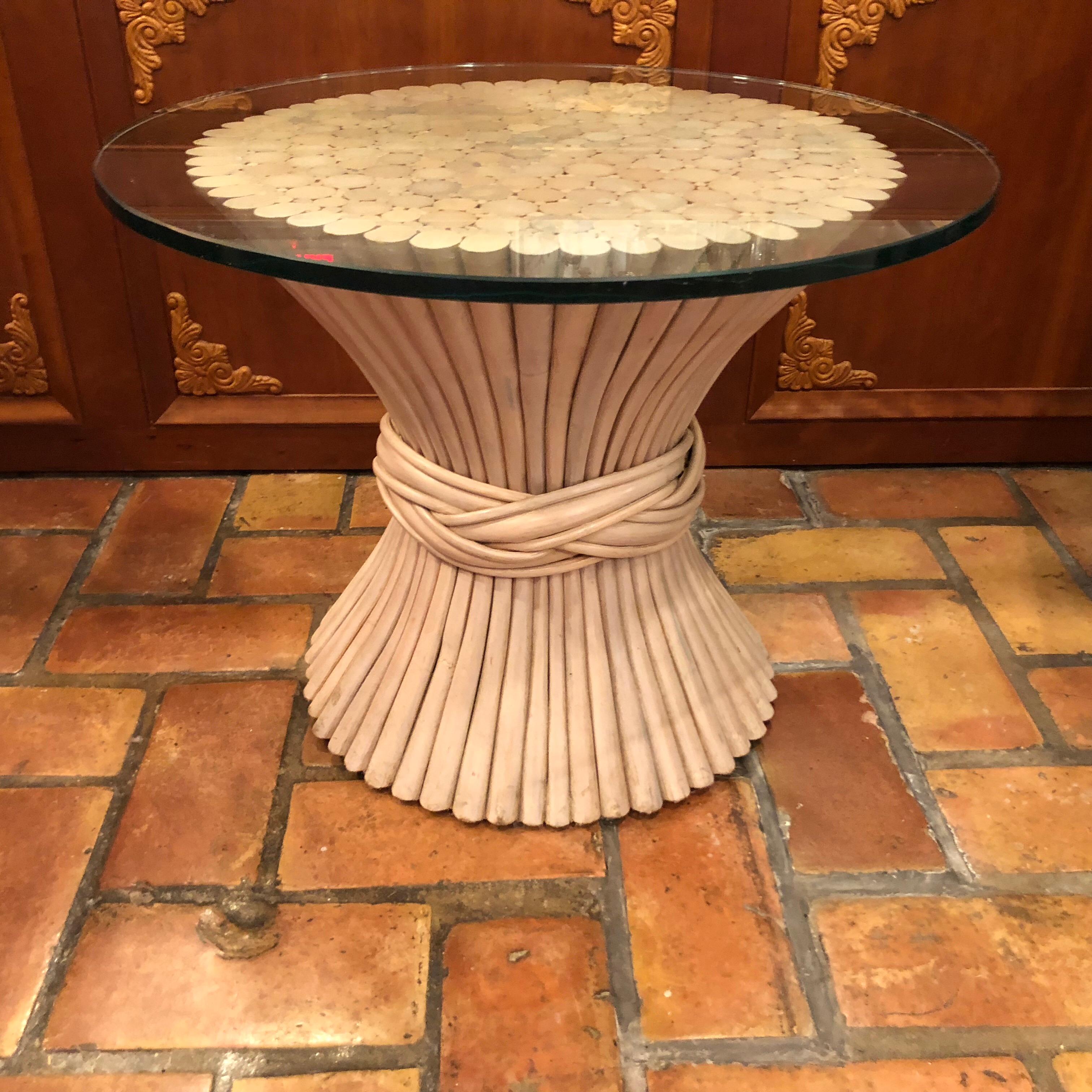 McGuire Bamboo side table wheat sheath base. Nice size side or end table, perfect for in between a pair of chairs. Nice finish and texture. Thick round glass top evenly balance on this channeled bamboo sculptural base.
Light whitewash finish on