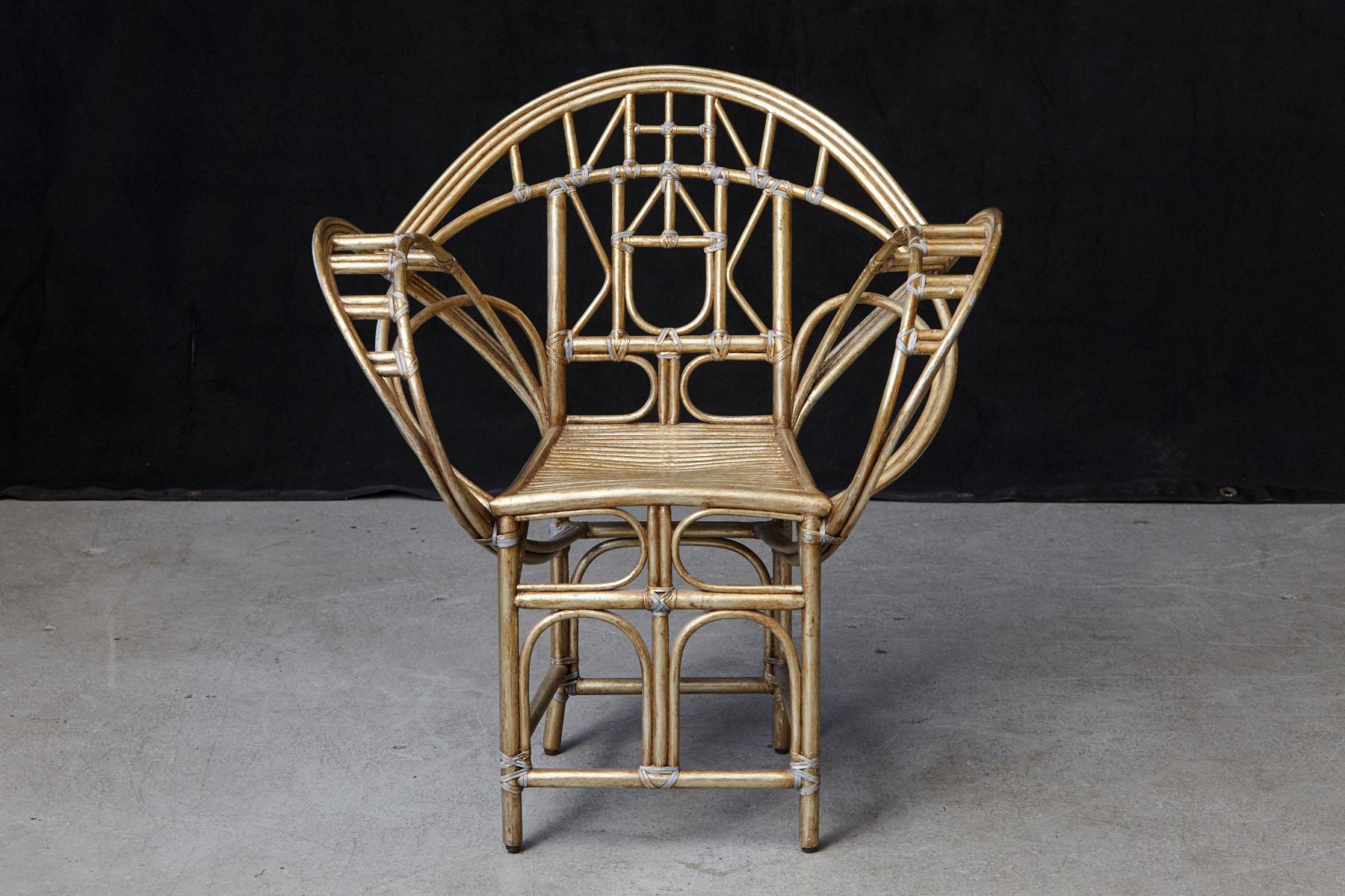 Designed by Edward Tuttle, McGuire's famous Butterfly chair is a study in fluidity. This graceful design features sweeping arms of delicate rattan. The arching back displays a symmetric series of both curved and geometric rattan members. Likewise,