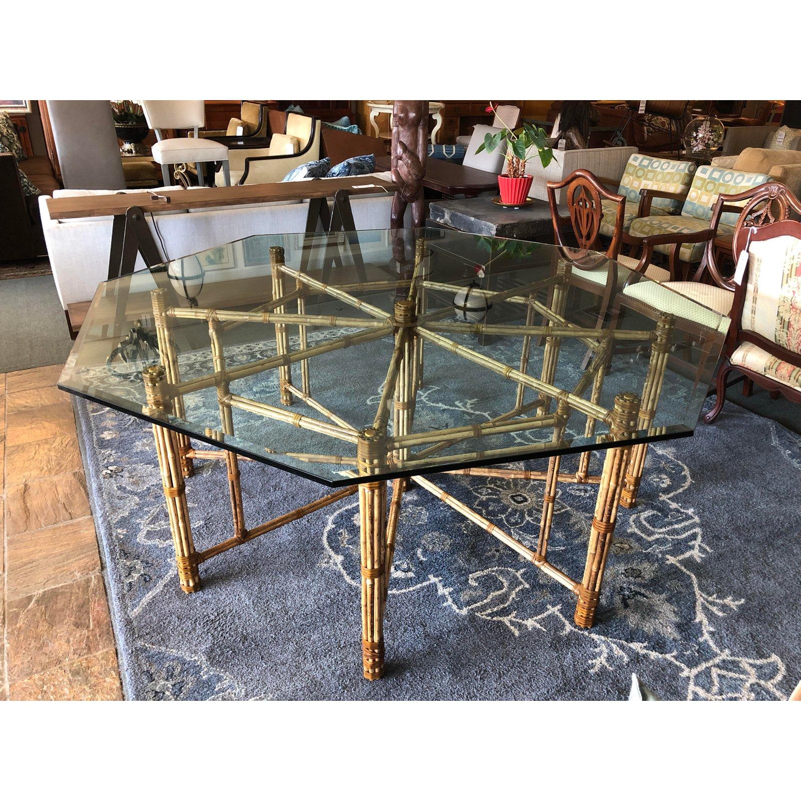 A large McGuire dining table. Designed by John McGuire. Beautiful bamboo rods are lashed together with McGuire's signature raw hide lacing in an intricate pattern that comfortably seats eight. The base is topped with 3/4