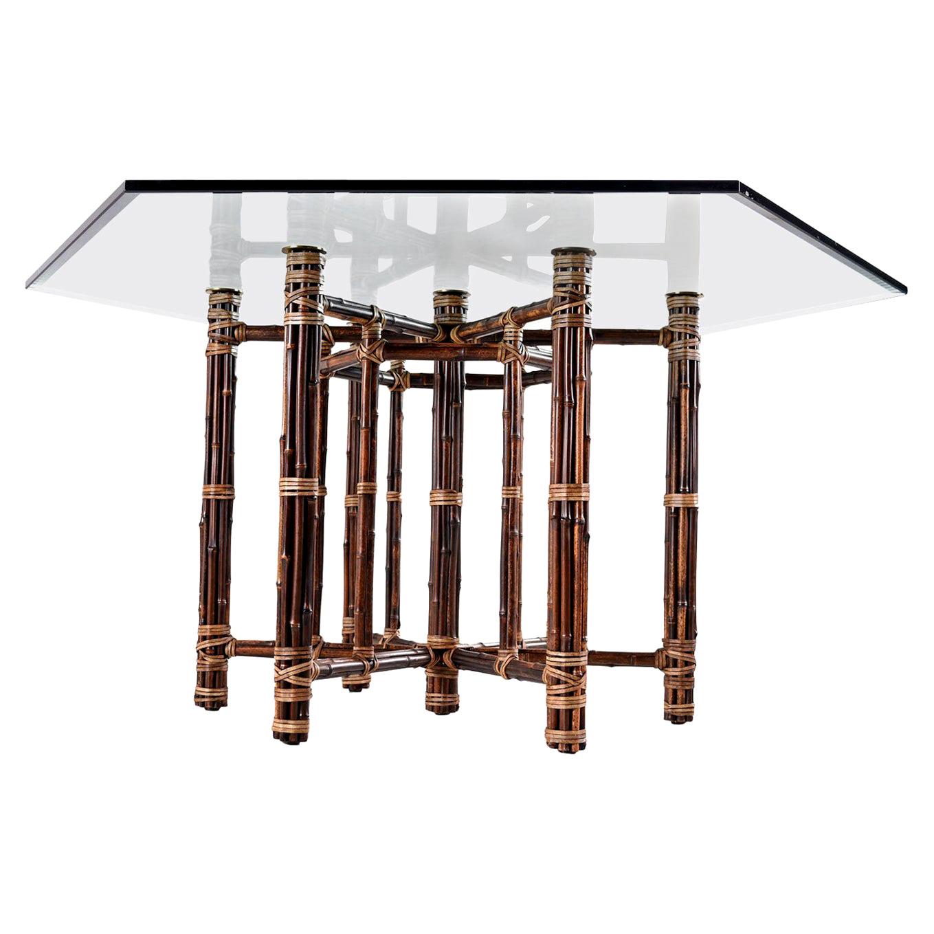 Hard to find vintage McGuire dining table. Designed by Leonard Linden for John and Elinor McGuire in the 1950s, we estimate the birth of this table (from the patina) between 1950s and 1960s. We love the combination of patinated rattan, brass cap