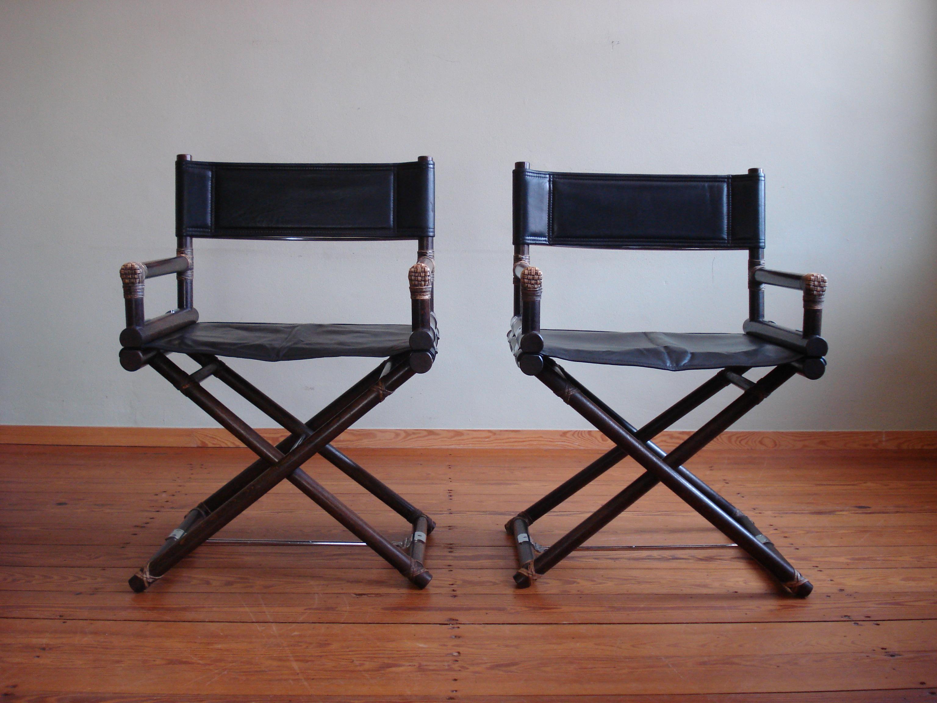 Rare set of 2 late 1950s McGuire X-Chairs in beautiful tinted oak wood, black leather and silver-chrome hardware. 
Due to the age, there are minor signs of use and fixes, but nothing that shows on first sight or affects functionality. 
The leather