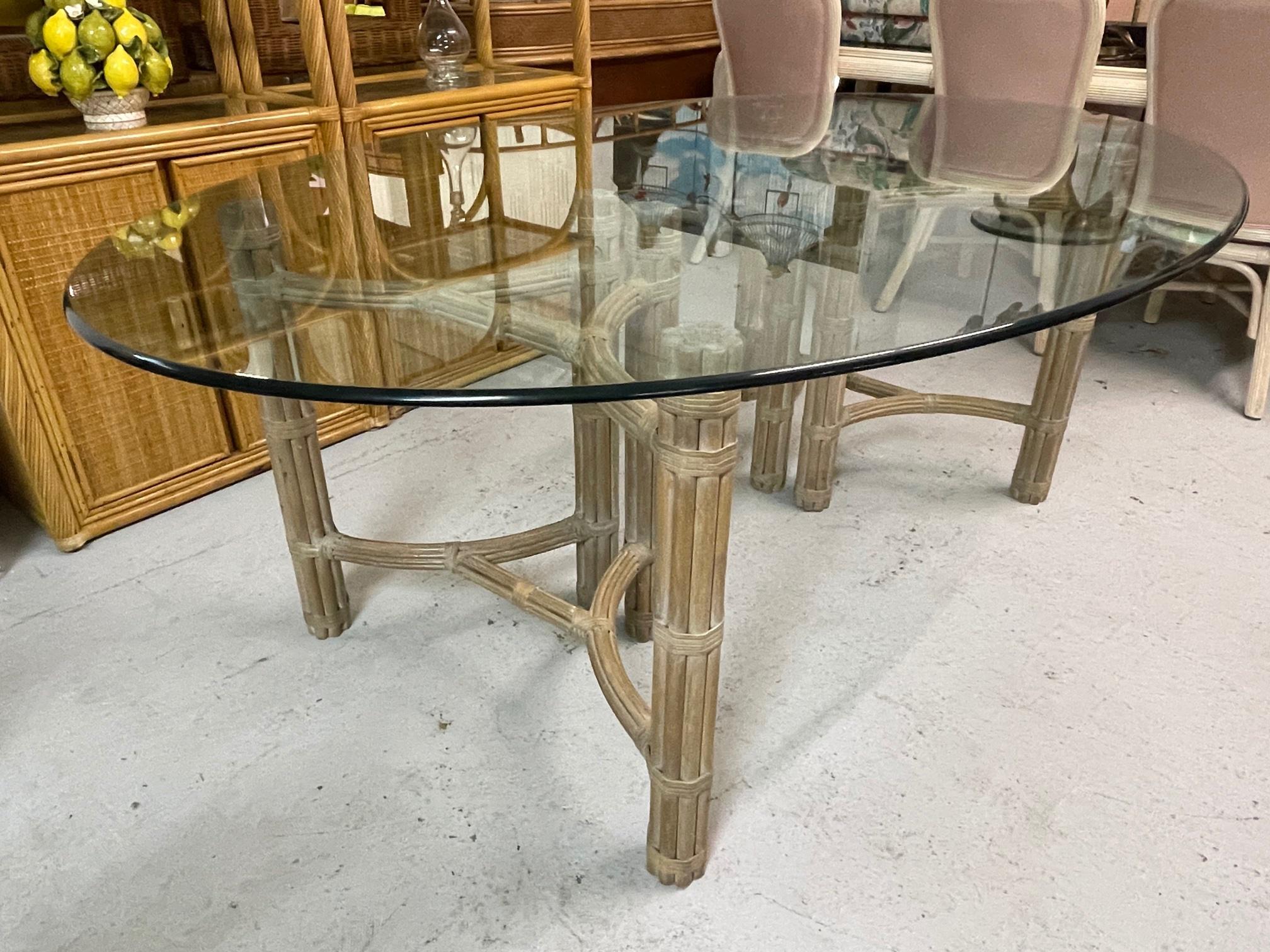Double pedestal dining table by McGuire features a steel core sheathed in rattan and a glass top. Good condition with minor imperfections consistent with age. May exhibit scuffs, marks, or wear, see photos for details.
For a shipping quote to your