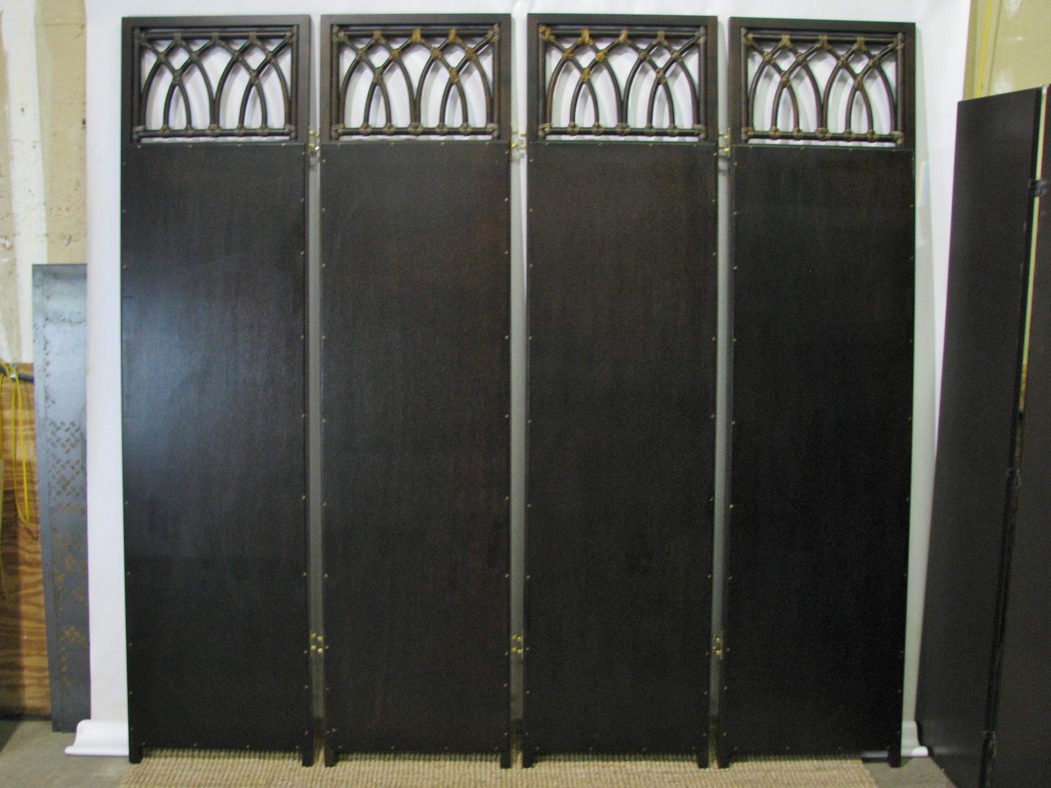 Beautifully designed and crafted vintage four-panel screen or room divider by McGuire. Unique Gothic arch over mirror design on the upper and lower sections. The arches are bound together by McGuire's signature leather strips. Extremely solid, and