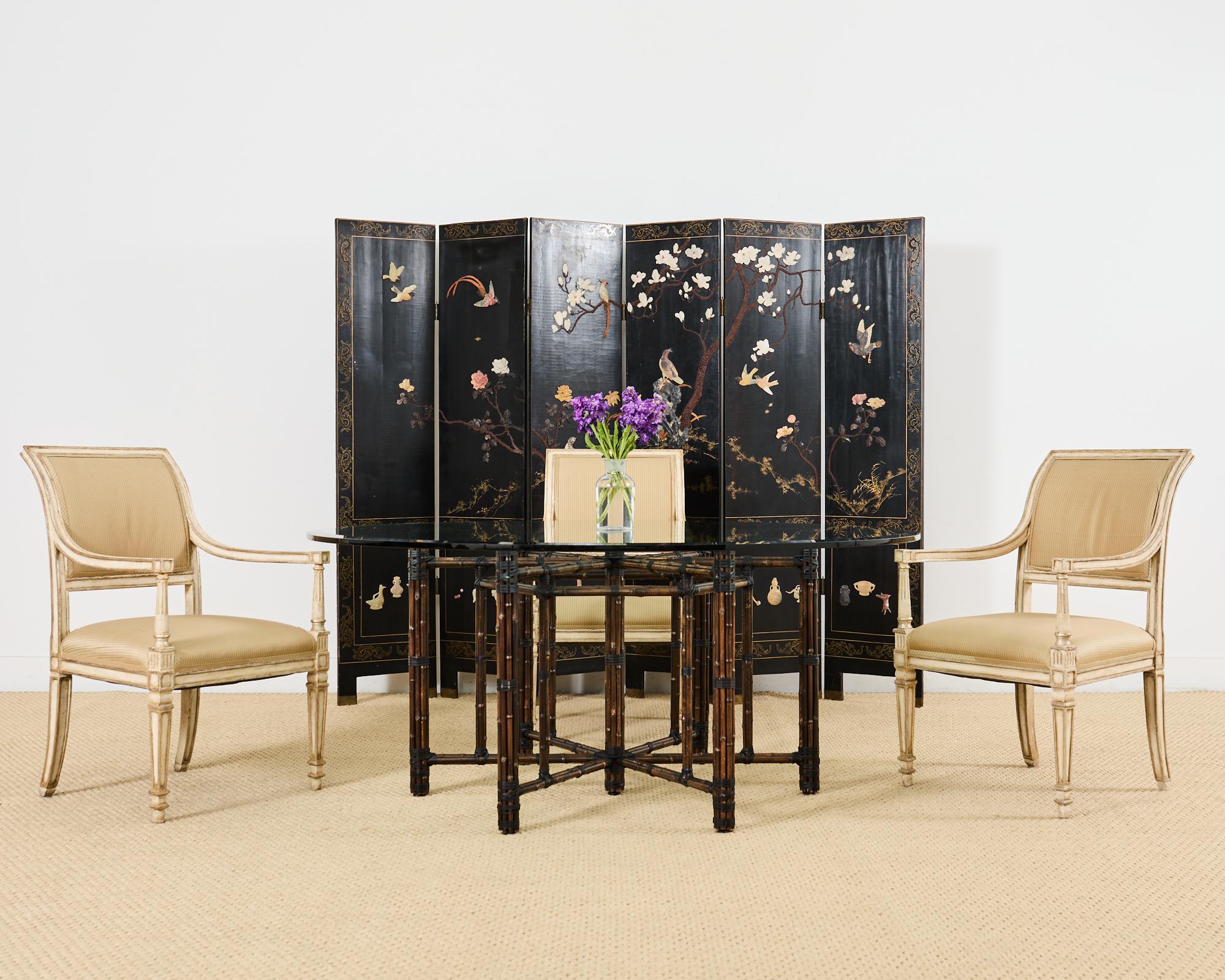 Genuine McGuire organic modern round dining table featuring a hexagonal shaped base. The iron base is painted golden gate orange for authenticity and then covered with bamboo poles lashed together with leather rawhide laces. This bespoke table was