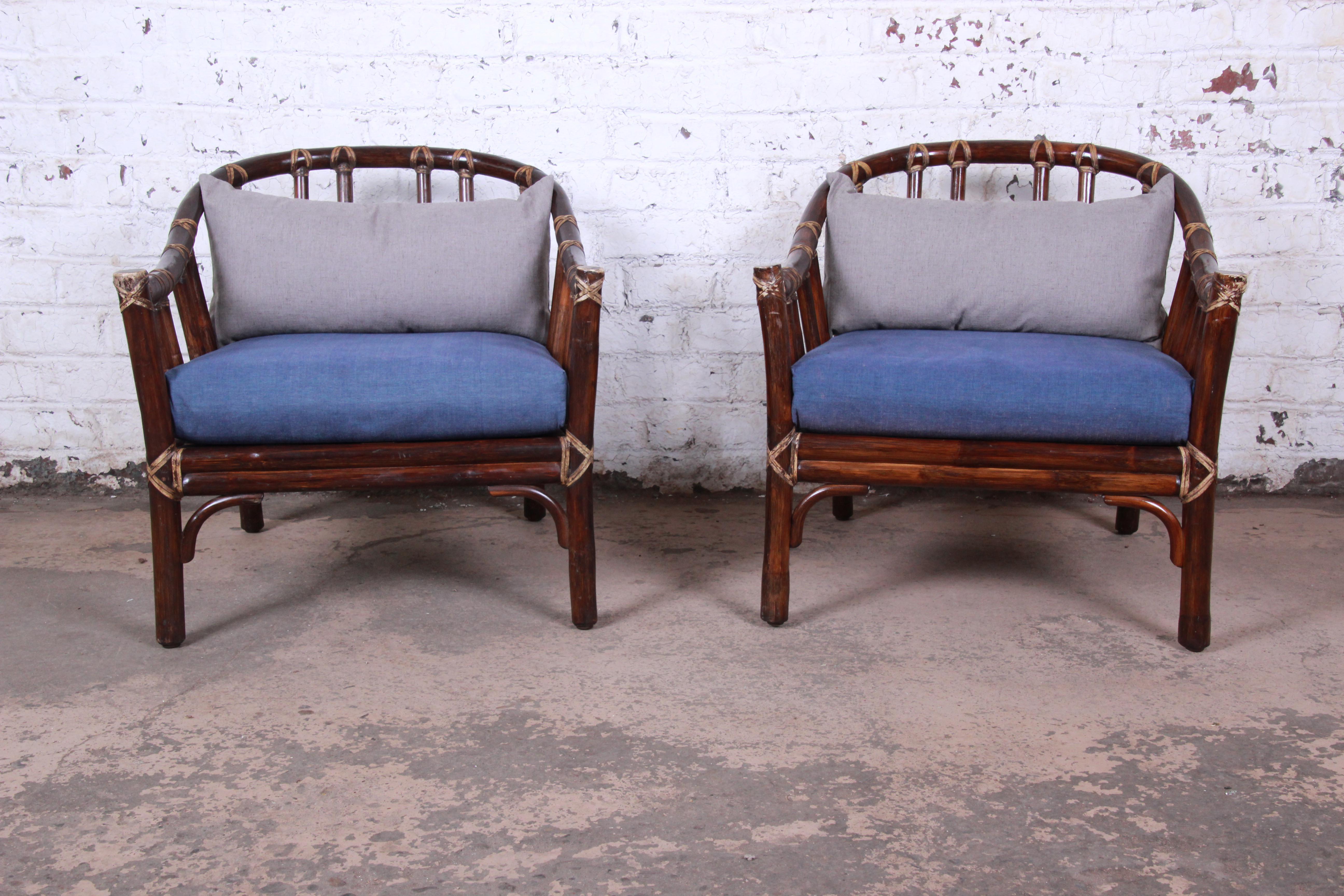 A gorgeous pair of midcentury Hollywood Regency club chairs by McGuire of San Francisco, circa 1978. The chairs are expertly constructed of bent rattan and hardwood, aged to perfection. Lacquer finish with beautiful depth and warmth. The original