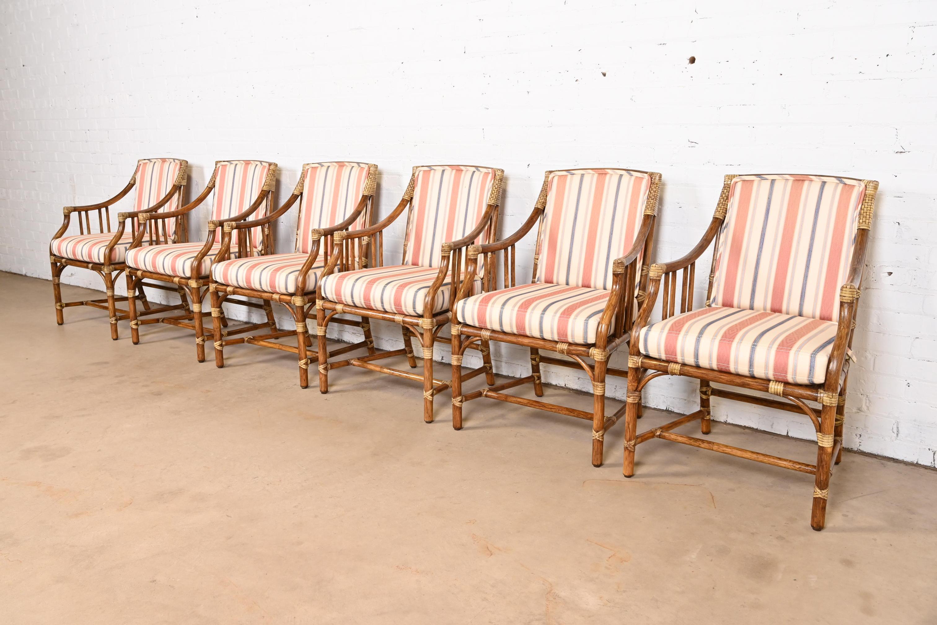 A gorgeous set of six Hollywood Regency organic modern bamboo rattan dining armchairs

By McGuire of San Francisco

USA, Circa 1980s

Bamboo rattan frames, with leather binding, and upholstered seat and back cushions.

Measures: 22.75