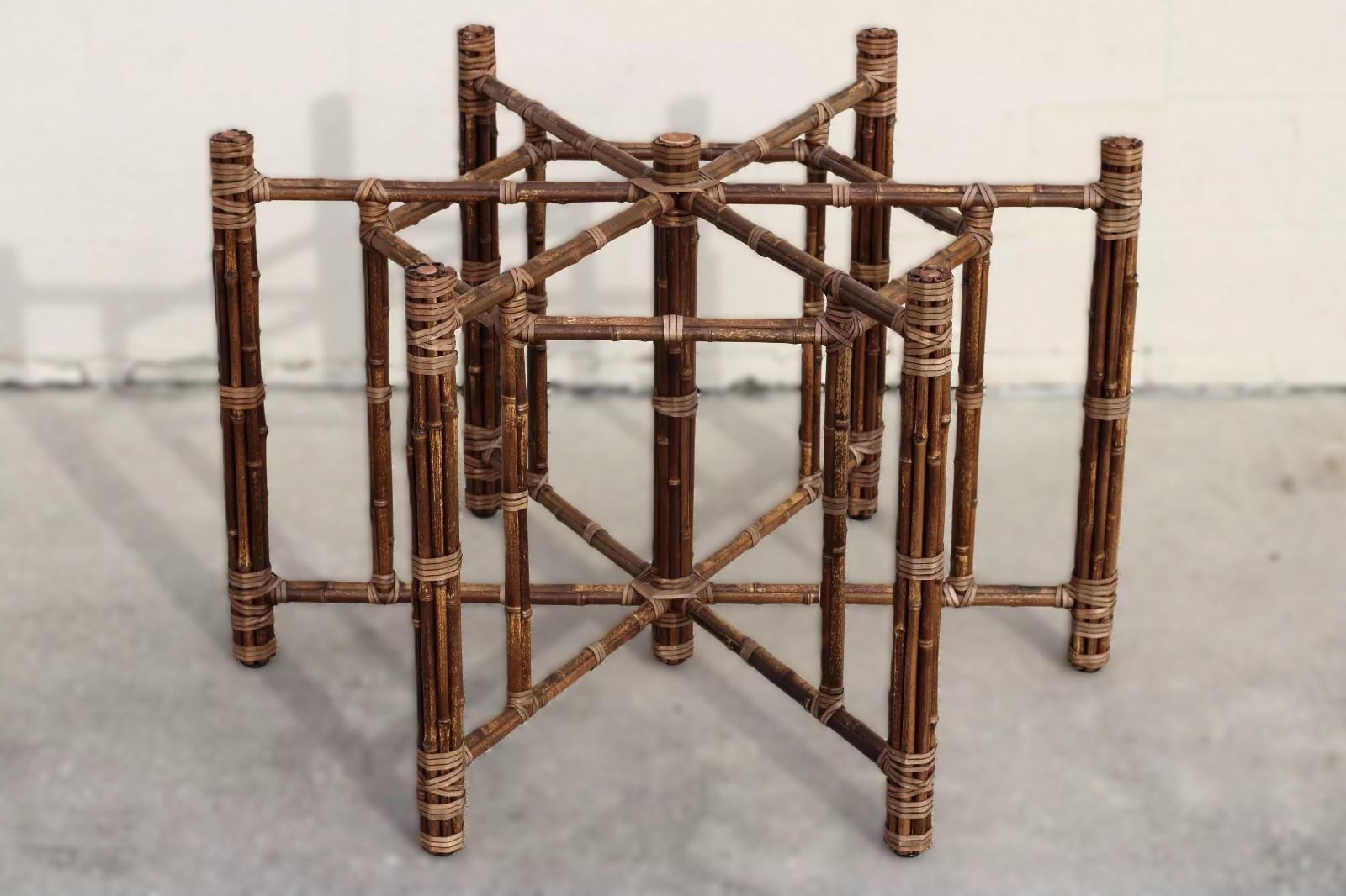 Stunning organic modern spotted bamboo dining table base for glass top designed by John McGuire. The dining table base, crafted entirely by hand, features bamboo poles lashed in place with McGuire's signature leather rawhide laces and has an iron