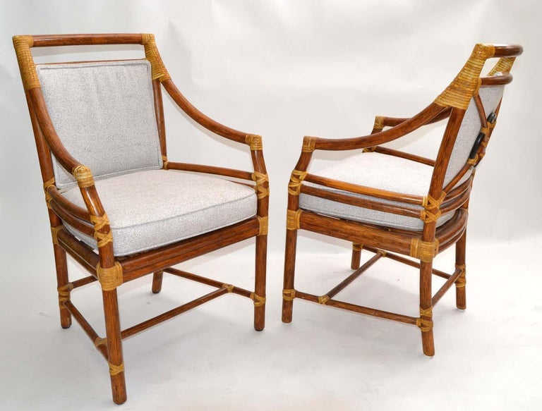 Pair of original McGuire bamboo and handwoven cane armchair, dining chair with leather bindings.
The upholstery is a beige boucle Fabric and note the stunner done backrest.
McGuire metal tag is attached underneath.
Measures: Arm height 25
