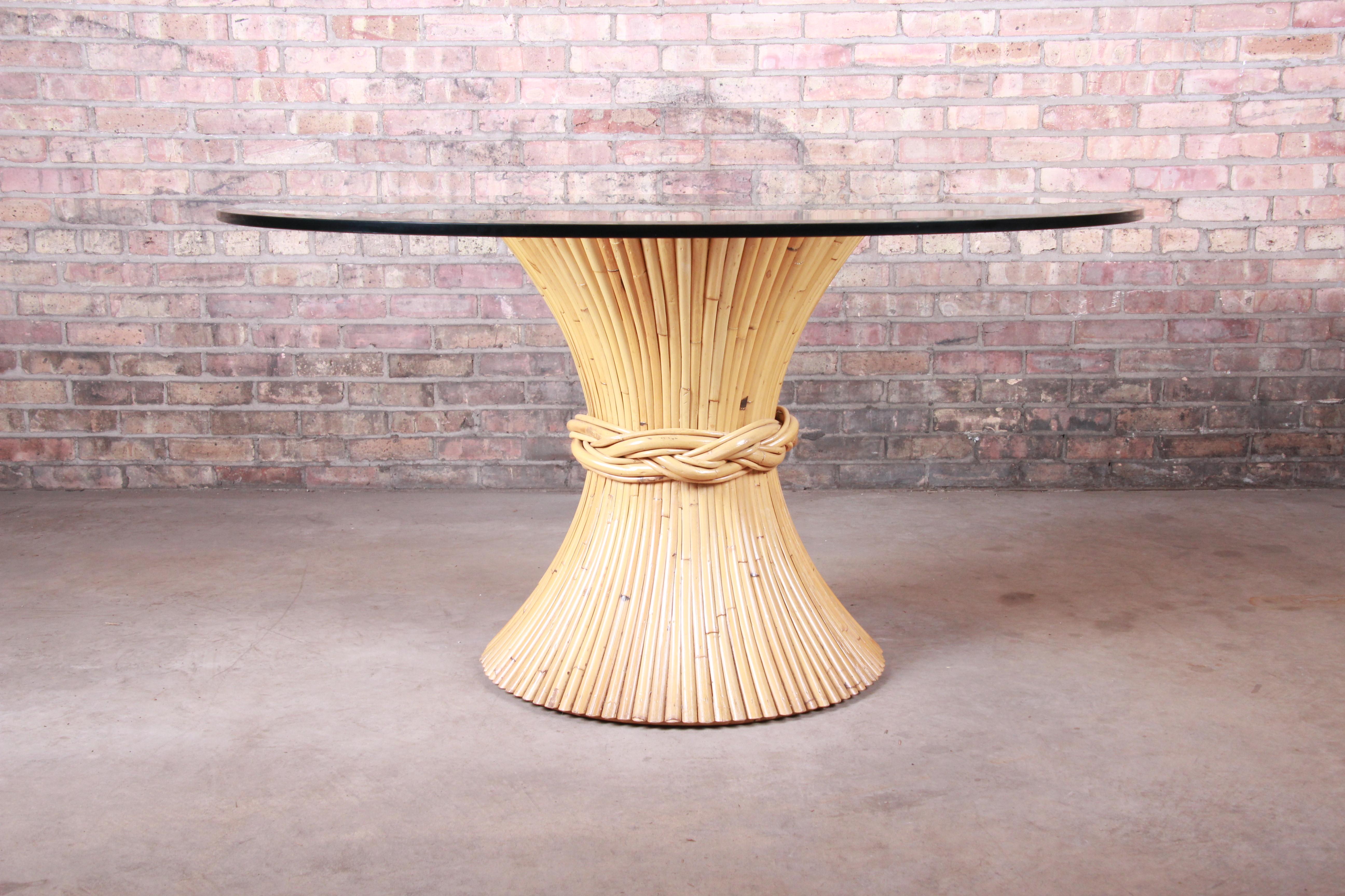 A gorgeous Mid-Century Modern Hollywood Regency bamboo sheaf of wheat pedestal dining table

By McGuire of San Francisco

USA, circa 1970s

Bamboo base in sheaf of wheat form, with thick beveled glass top.

Measures: 54