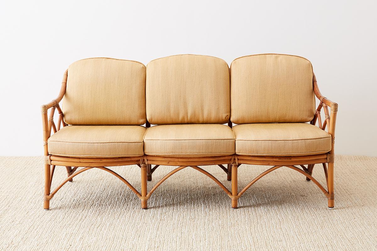 Fabulous McGuire Furniture Mid-Century Modern bamboo rattan sofa. Features construction using organic modern materials and designs McGuire is famous for. The case is made from bent rattan reinforced with leather rawhide strapping. The frame is