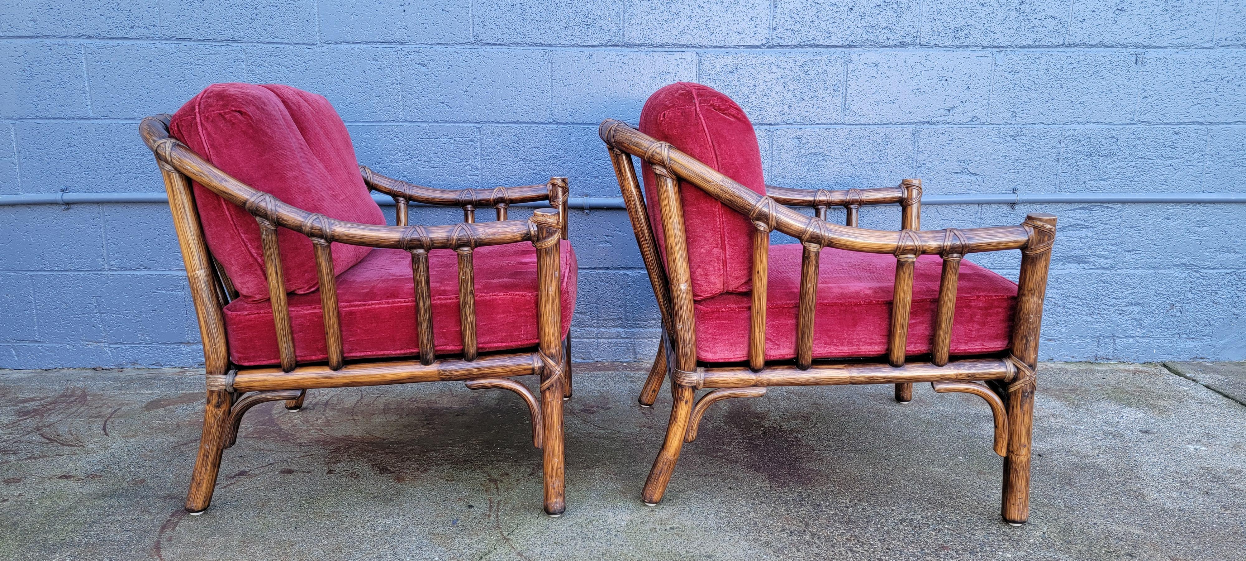 A fine pair of bamboo lounge chairs by McGuire Furniture of San Francisco, California. Quality crafted with leather bindings. Retain brass 