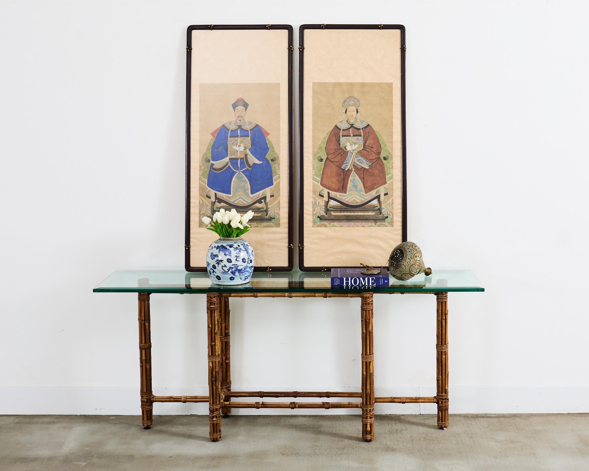 Elongated McGuire console table or sofa table made in the California organic modern style. The rectangular table features an iron base finished in golden gate orange for authenticity wrapped in bamboo poles lashed together with contrasting leather