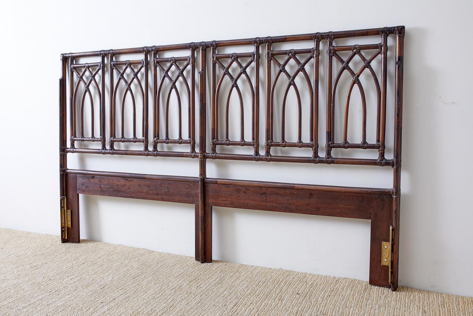 Large California organic modern style bamboo rattan headboard crafted by McGuire. Features a frame constructed of bamboo rattan poles lashed together with leather rawhide laces. The frame is decorated with six windows having a cathedral arch motif