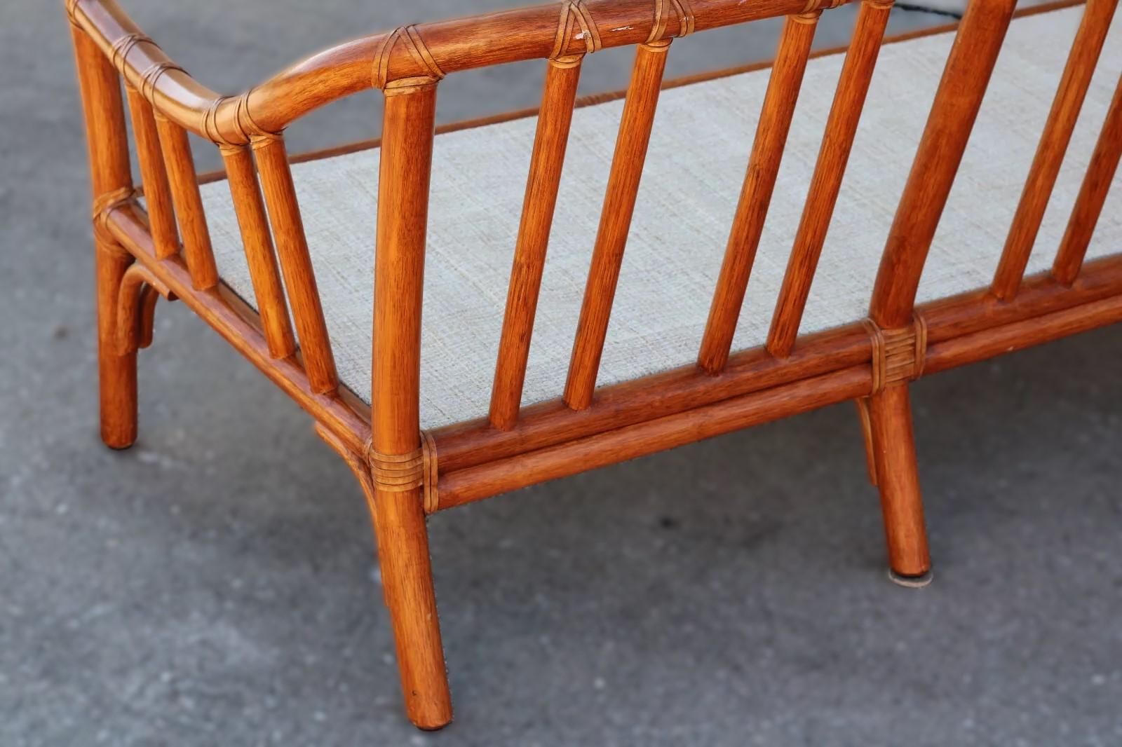 Sofá moderno y orgánico de ratán de bambú diseñado por la innovadora Elinor McGuire para McGuire San Francisco. El sofá o canapé de tres plazas presenta un armazón de ratán curvado hecho a mano junto con el cordón de cuero crudo característico de