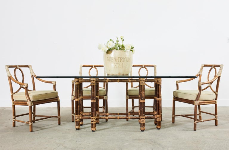 Stunning bamboo rectangular dining table made in the California organic modern style by McGuire. This is a genuine McGuire model # MCBA22 with an iron frame painted golden gate orange for authenticity. The table features a geometric design base