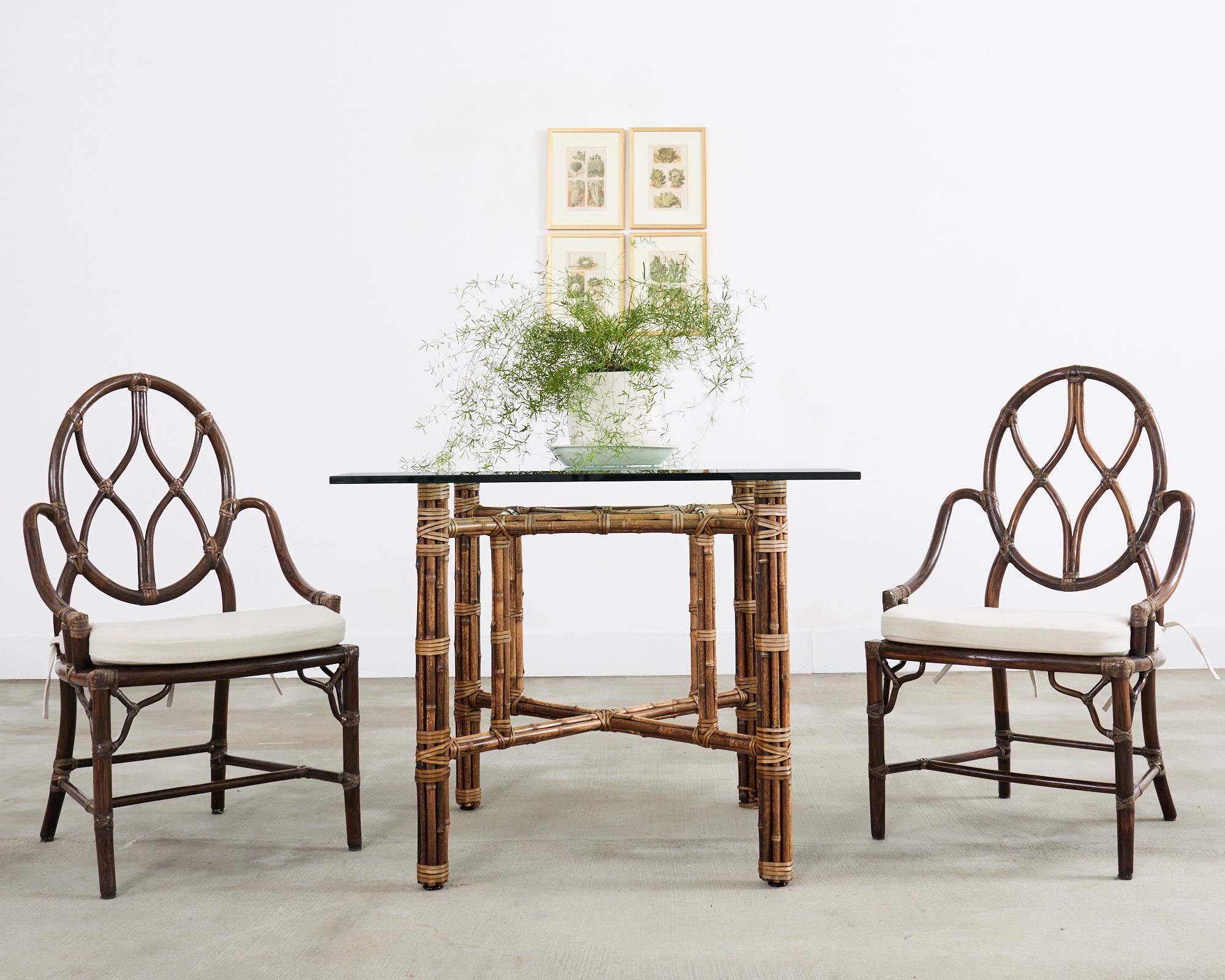 Distinctive genuine McGuire square shaped breakfast dining table made in the California coastal organic modern style. Authentic McGuire, not a reproduction featuring an iron frame painted golden gate orange for authenticity. The square shaped frame