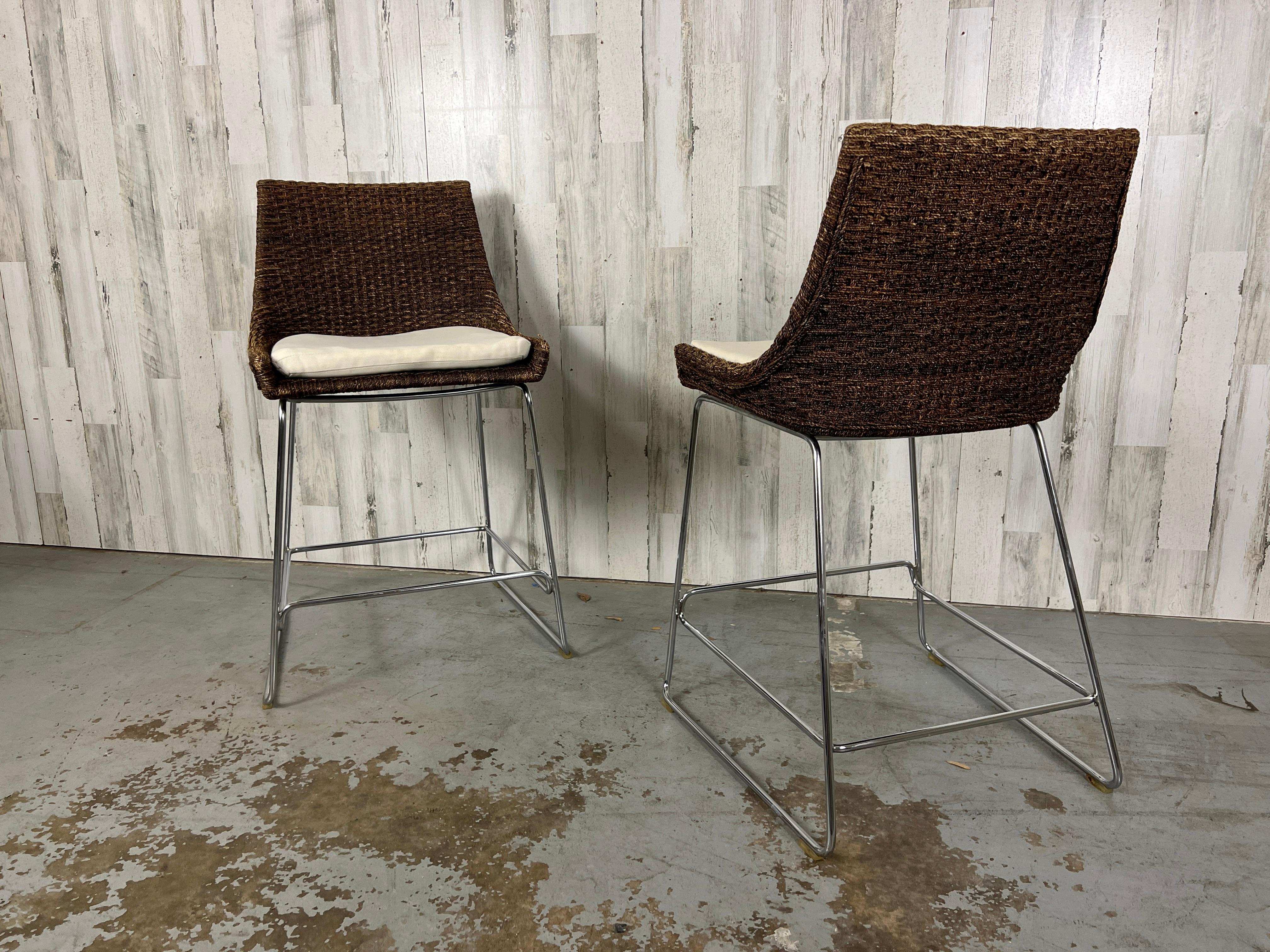 Counter height stools with woven Coco Abaca on top of a chrome sled style base.