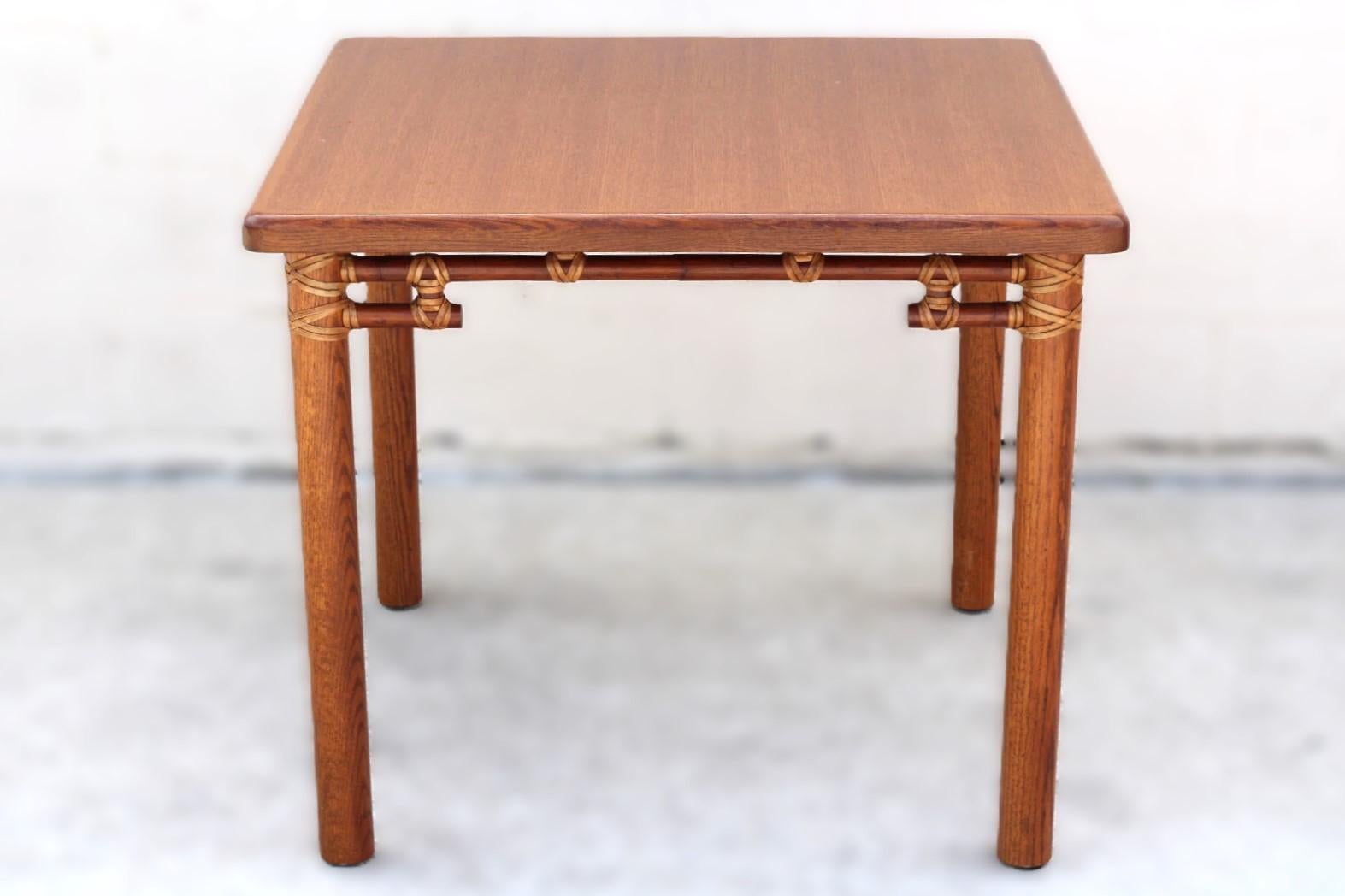 Genuine McGuire organic modern oak and rattan bamboo game table. The thick oak top of this card table has a beautiful fine linear oak grain and rounded edges and corners. The oak top is supported by four round legs of solid oak. McGuire artisans