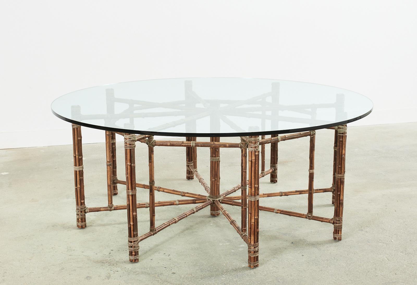 Gorgeous genuine McGuire organic modern bamboo rattan dining table featuring an octagonal base with seating for eight. This is an authentic McGuire table with an iron frame painted Golden Gate orange for authenticity, not a cheap reproduction. The