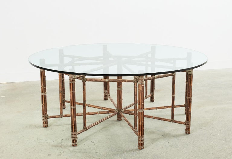 Gorgeous genuine McGuire organic modern bamboo rattan dining table featuring an octagonal base with seating for eight. This is an authentic McGuire table with an iron frame painted Golden Gate orange for authenticity, not a cheap reproduction. The