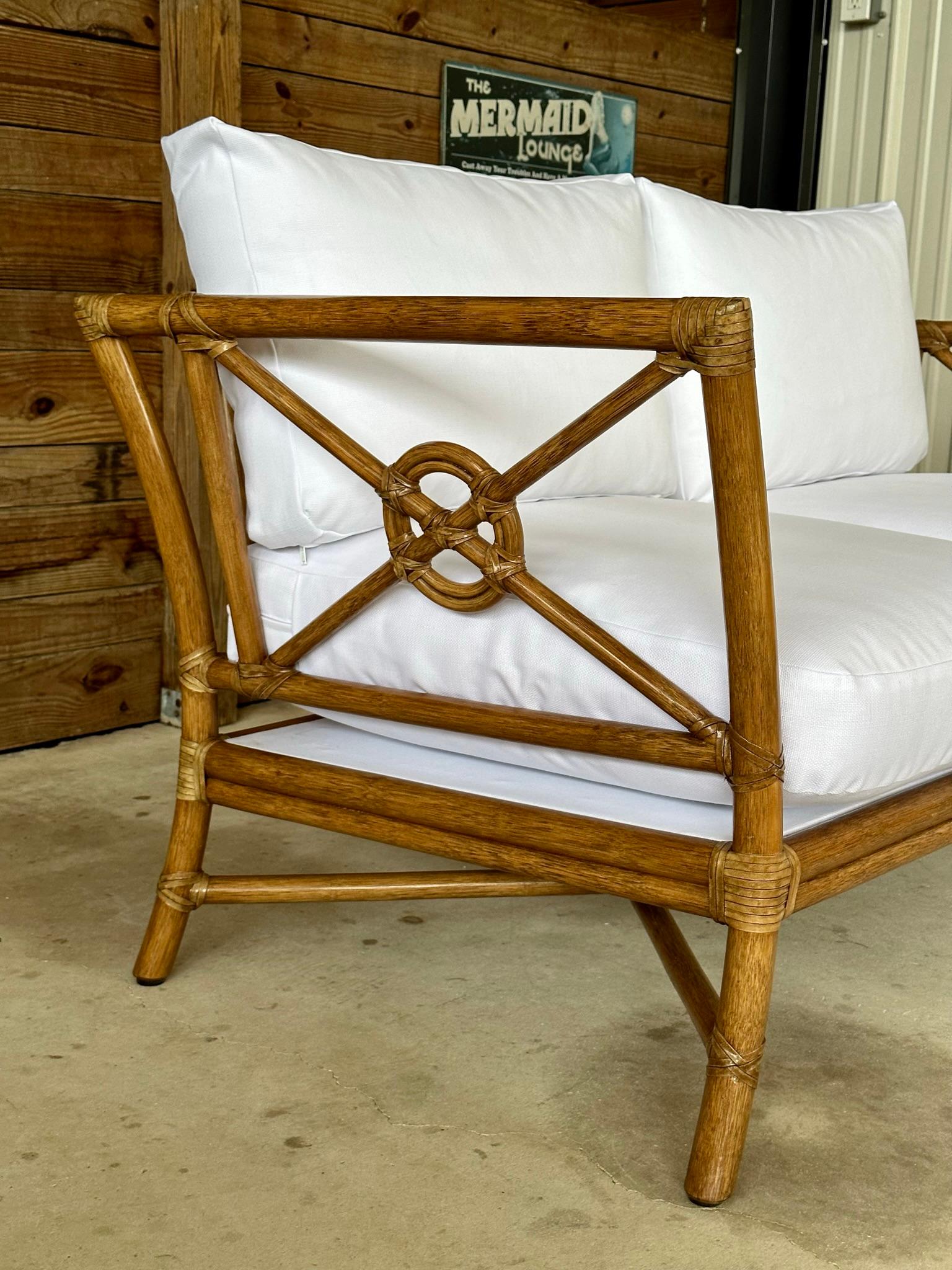 Marked: McGuire rattan target settee and or loveseat with new custom white Sunbrella fabric for an organic modern Coastal style.
Settee frame has been refinished with minimal wear along with new fabric added to the existing McGuire cushion insets