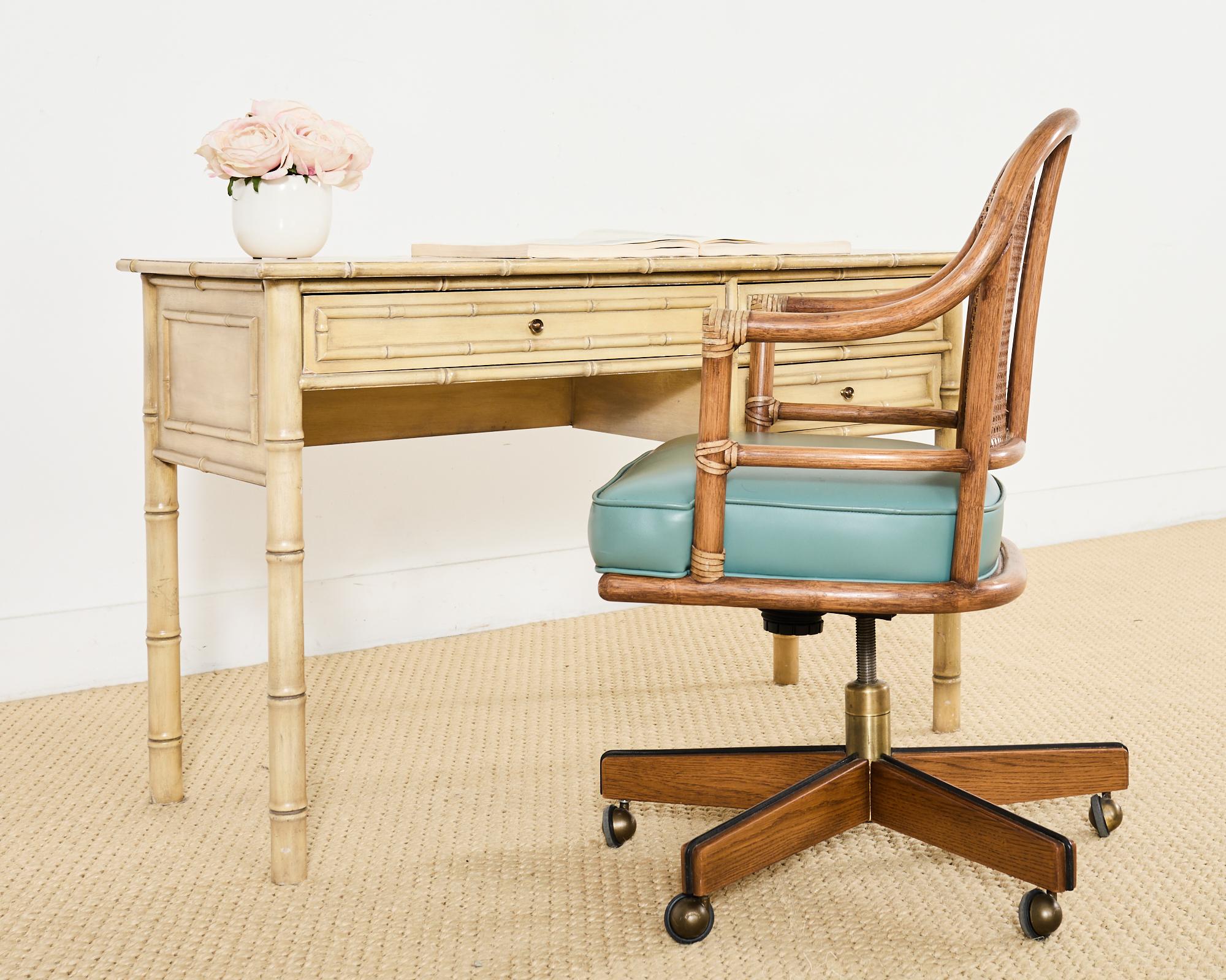 Rare mid-century modern executive office desk armchair made in the California coastal organic modern style by McGuire artisans. Genuine labeled McGuire desk chair featuring an oak and rattan frame with a caned back. The gracefully curved back is