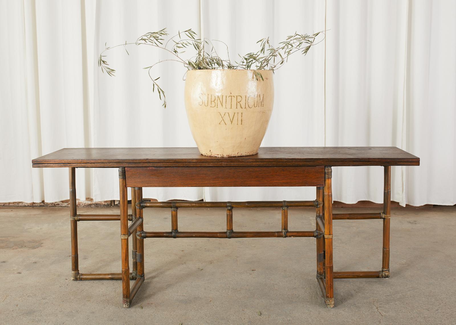 Versatile bamboo rattan console table, server, or writing table desk made by McGuire in the California organic modern style. The table features an expandable flip-top crafted from oak. The top expands from 18 inches deep to 36 inches deep to make a