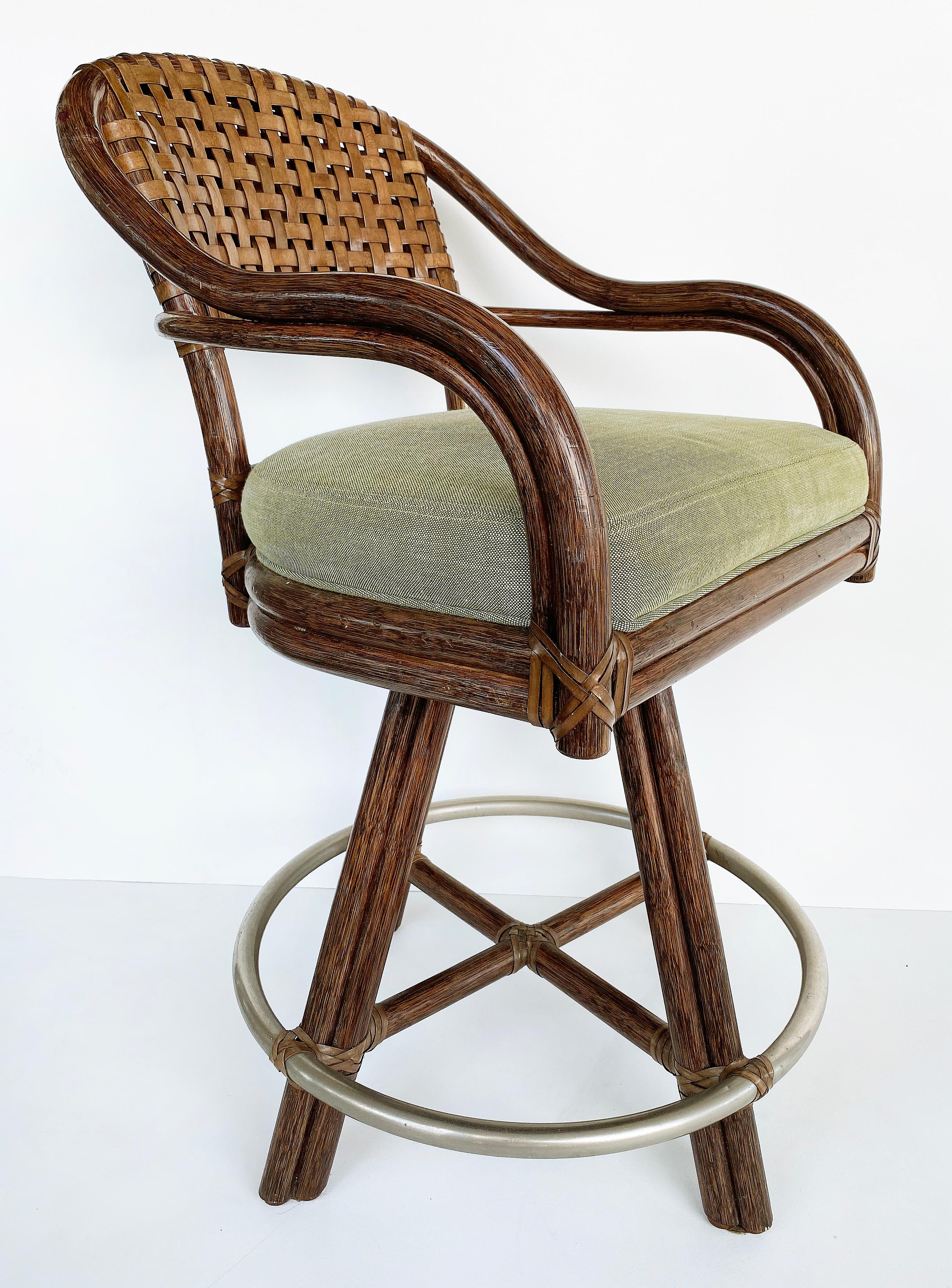 McGuire San Francisco Rattan, Rawhide swivel stools, pair

Offered for sale is a pair of swivel bar stools manufactured by McGuire of San Francisco. The frames of these stools are made of rattan with upholstered seat cushions. The curved backs