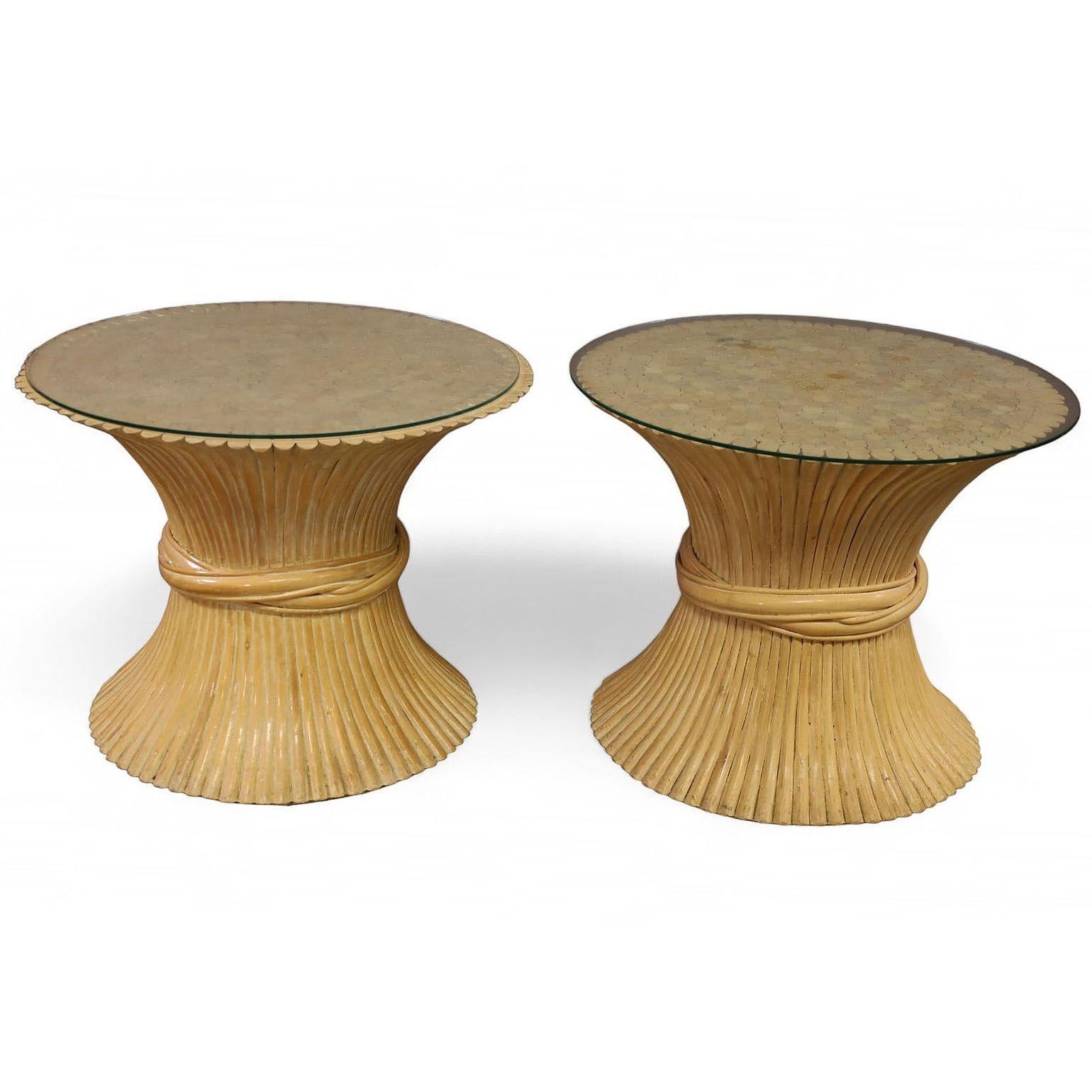A pair of rattan side tables by McGuire feature sculptural organic modern hourglass design and glass tops. The McGuire 