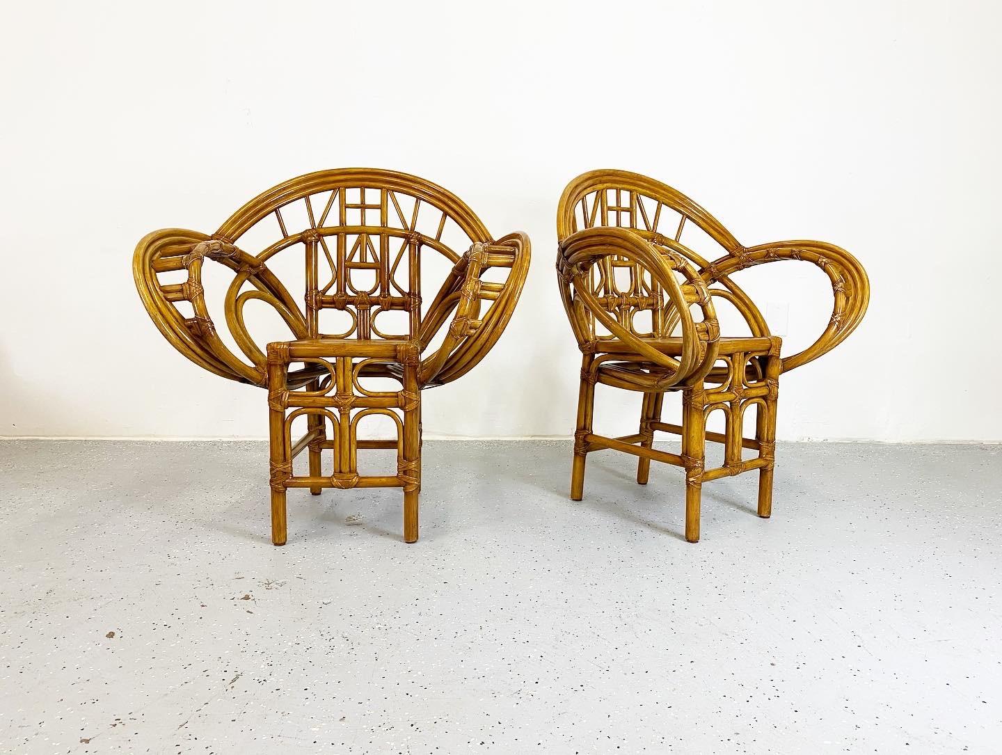 Beautiful vintage pair of side chairs in great condition. These have a wonderful, expressive form and are sure to make a statement. Bamboo and rattan with leather wrap detail.
 