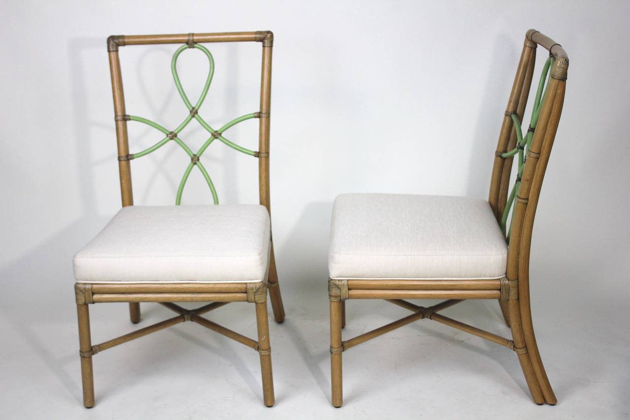 A stylish elegant vintage McGuire attributed pair of bamboo chairs. The chairs are very well constructed- with all multi wrapped corners, an X-cross base stretcher, original beautiful curvilinear ribbon shape bamboo back with a diamond center design