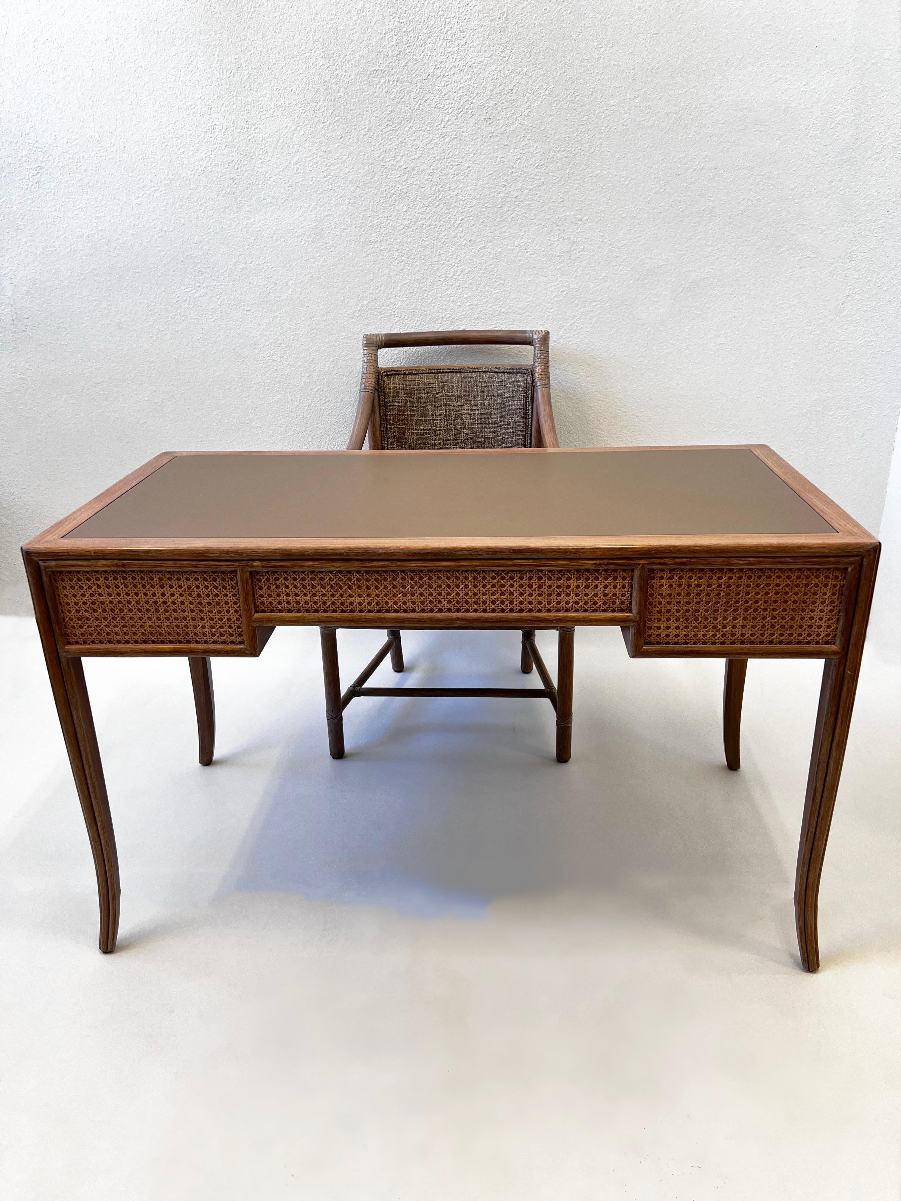 Beautiful 1970’s McGuire writing desk and chair design by Elinor McGuire. 
The desk is solid whitewashed oak, leather top with brass bamboo pulls.
Has three drawers. 
The chair is bamboo with hide straps, newly reupholstered.
Show minor wear