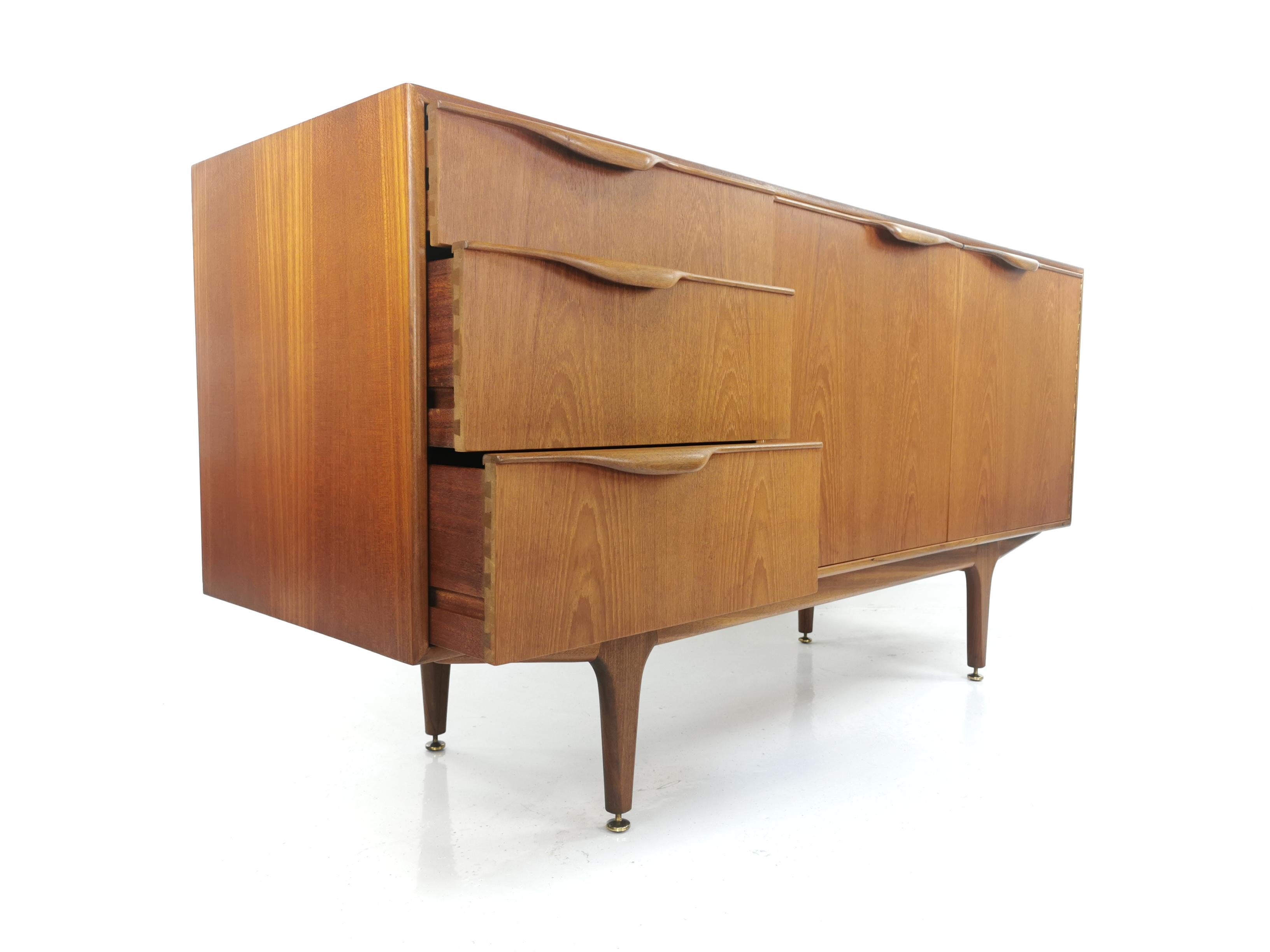 Mcintosh teak sideboard.

AH Mcintosh compact teak sideboard with fin handles. Designed by Tom Robertson, circa 1960s. 

The sideboard has three drawers one of which is lined with the original felt and a large cupboard space.

From the Dunvegan