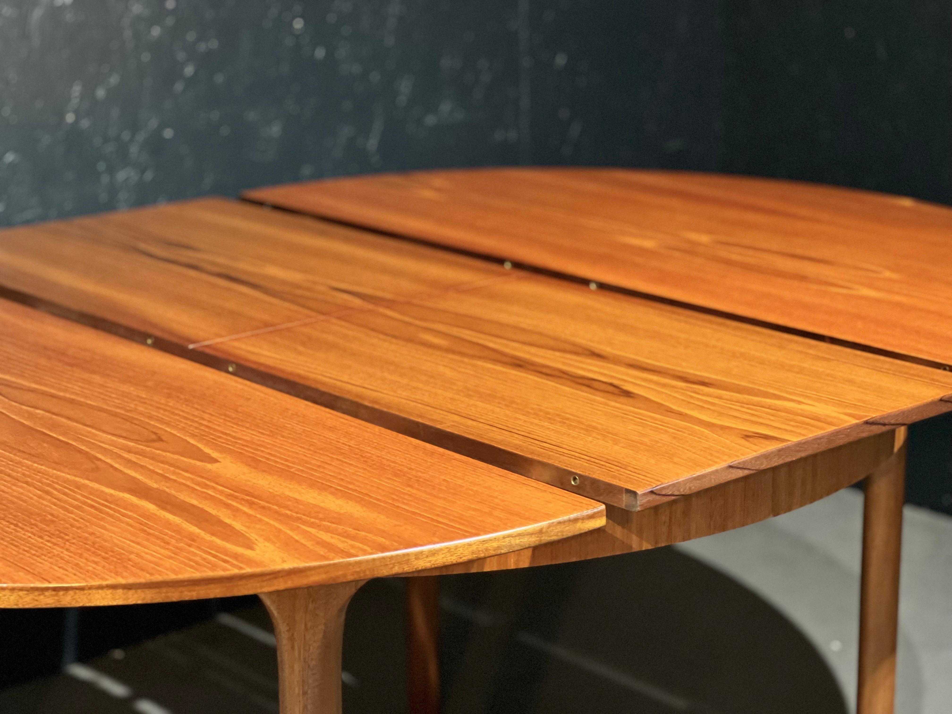 McIntosh table and chairs set.

The set is composed of the following:

Extendable round table in teak, belonging to the Dunvegan collection that Tom Robertson designed in the 1960s in Scotland.
The table has a solid teak structure, elegant