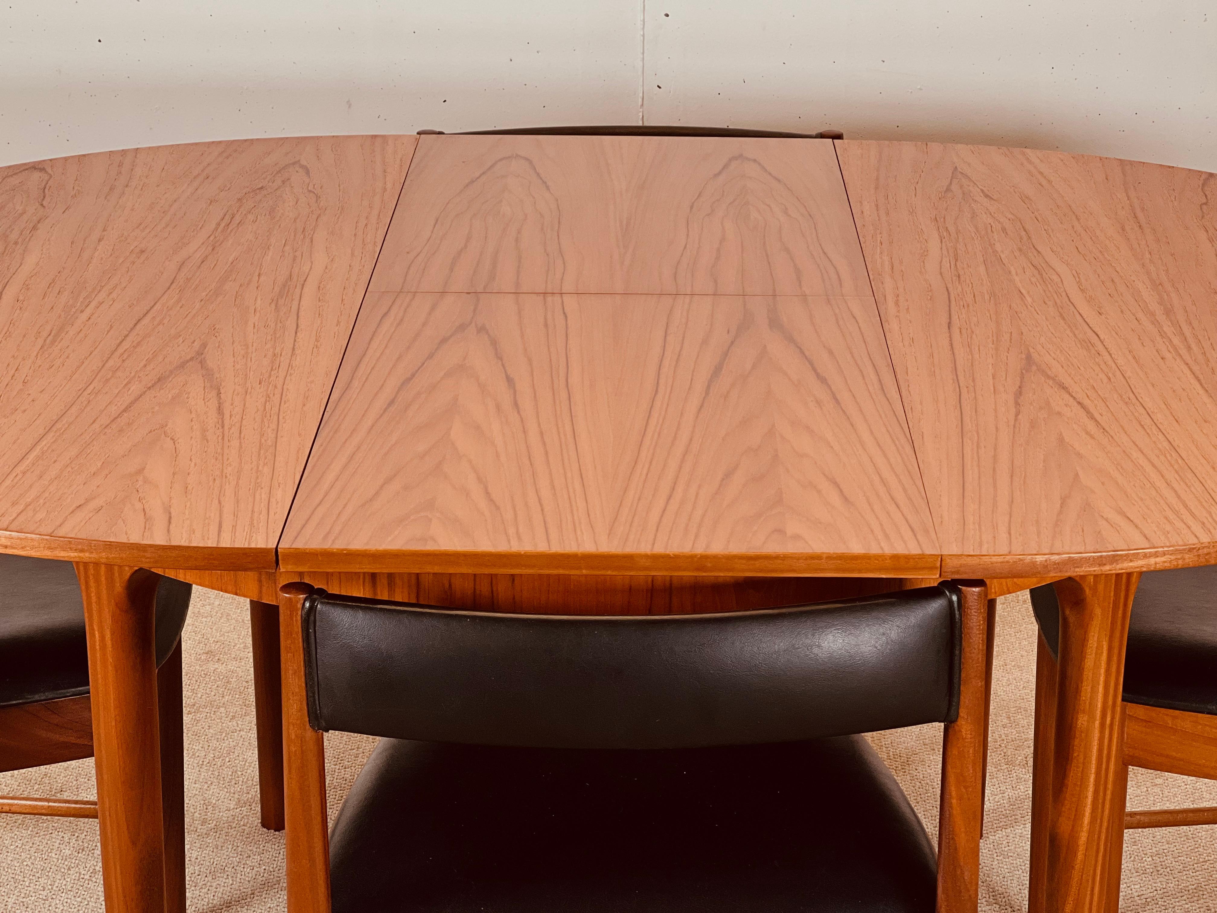 Mid-Century Modern McIntosh Round Extending Teak Dining Table and Chairs in Black Vinyl