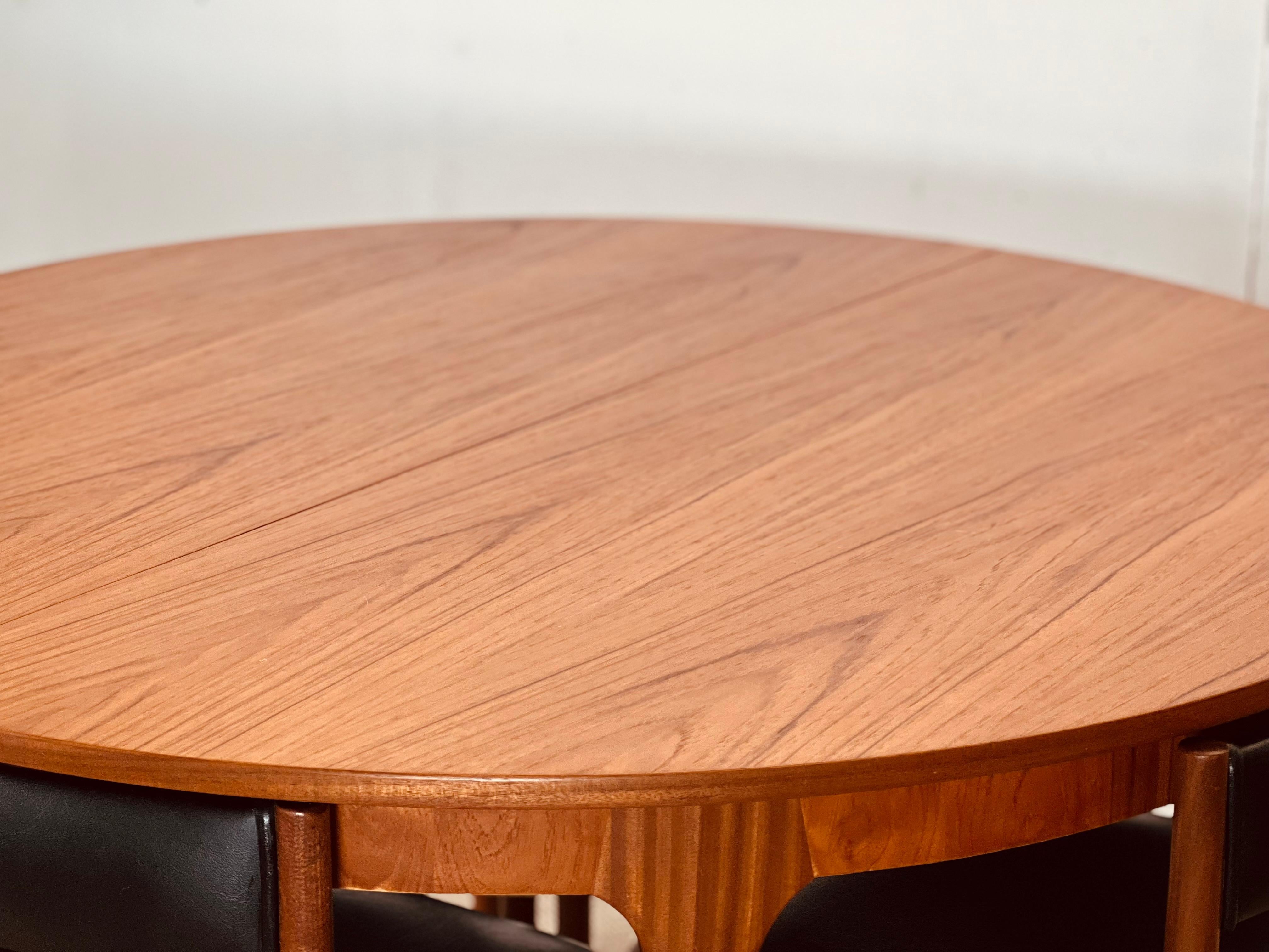 British McIntosh Round Extending Teak Dining Table and Chairs in Black Vinyl