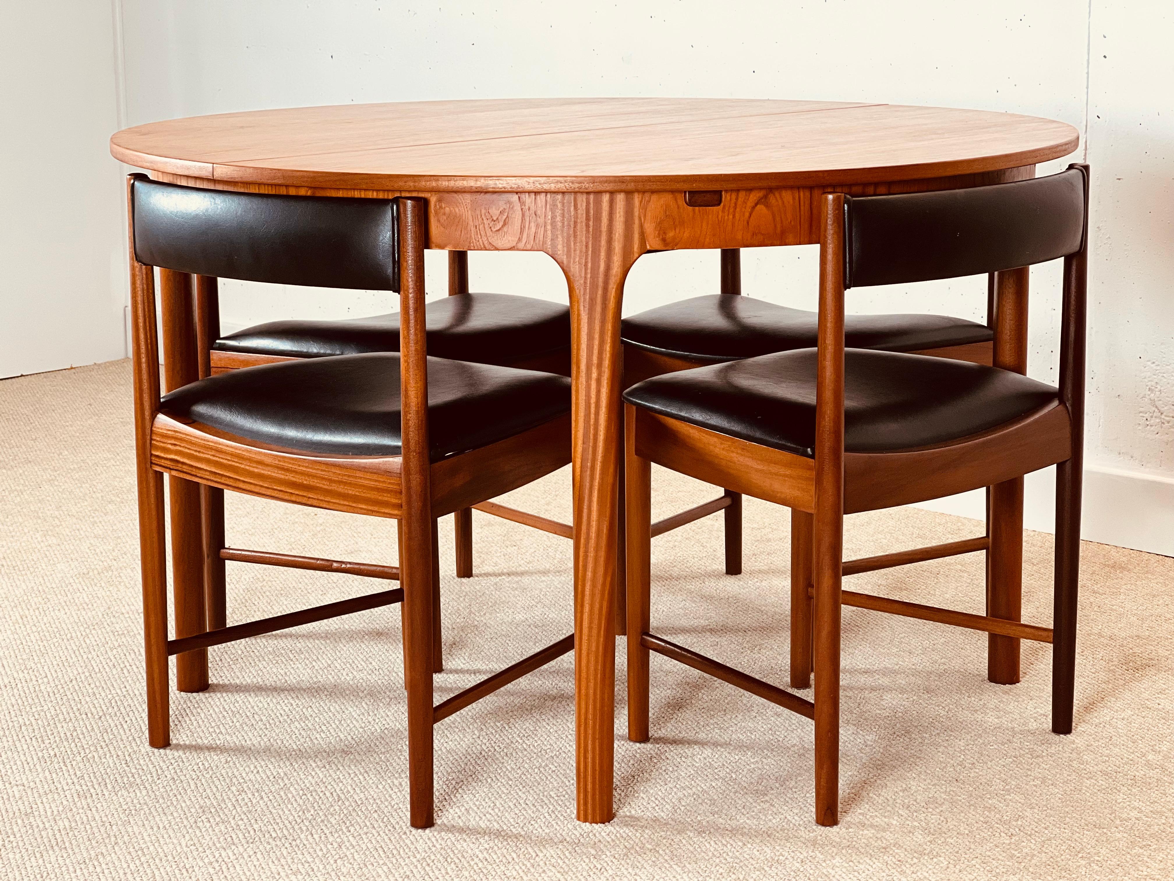 McIntosh Round Extending Teak Dining Table and Chairs in Black Vinyl In Excellent Condition In Buxton, GB