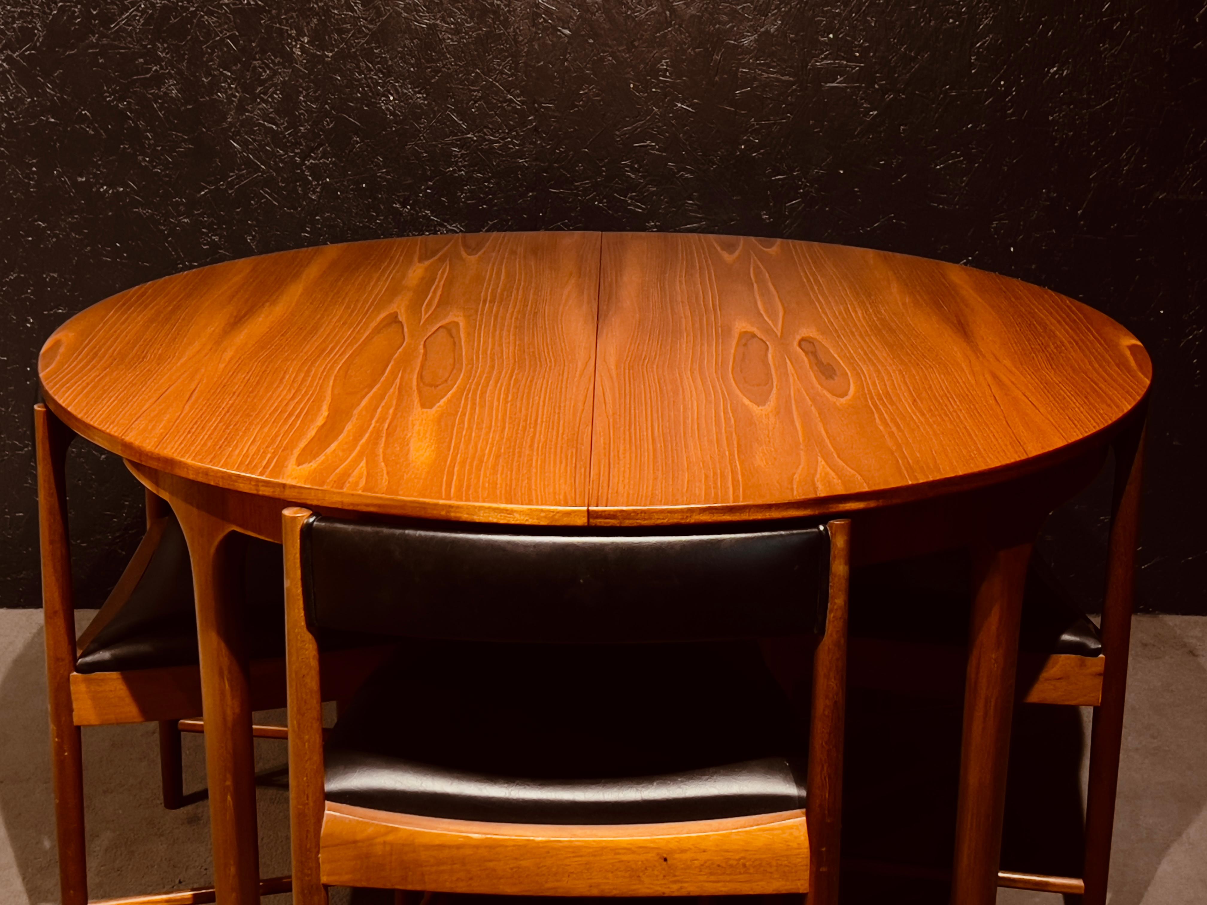 British McIntosh Round Extending Teak Dining Table and Chairs in Black Vinyl