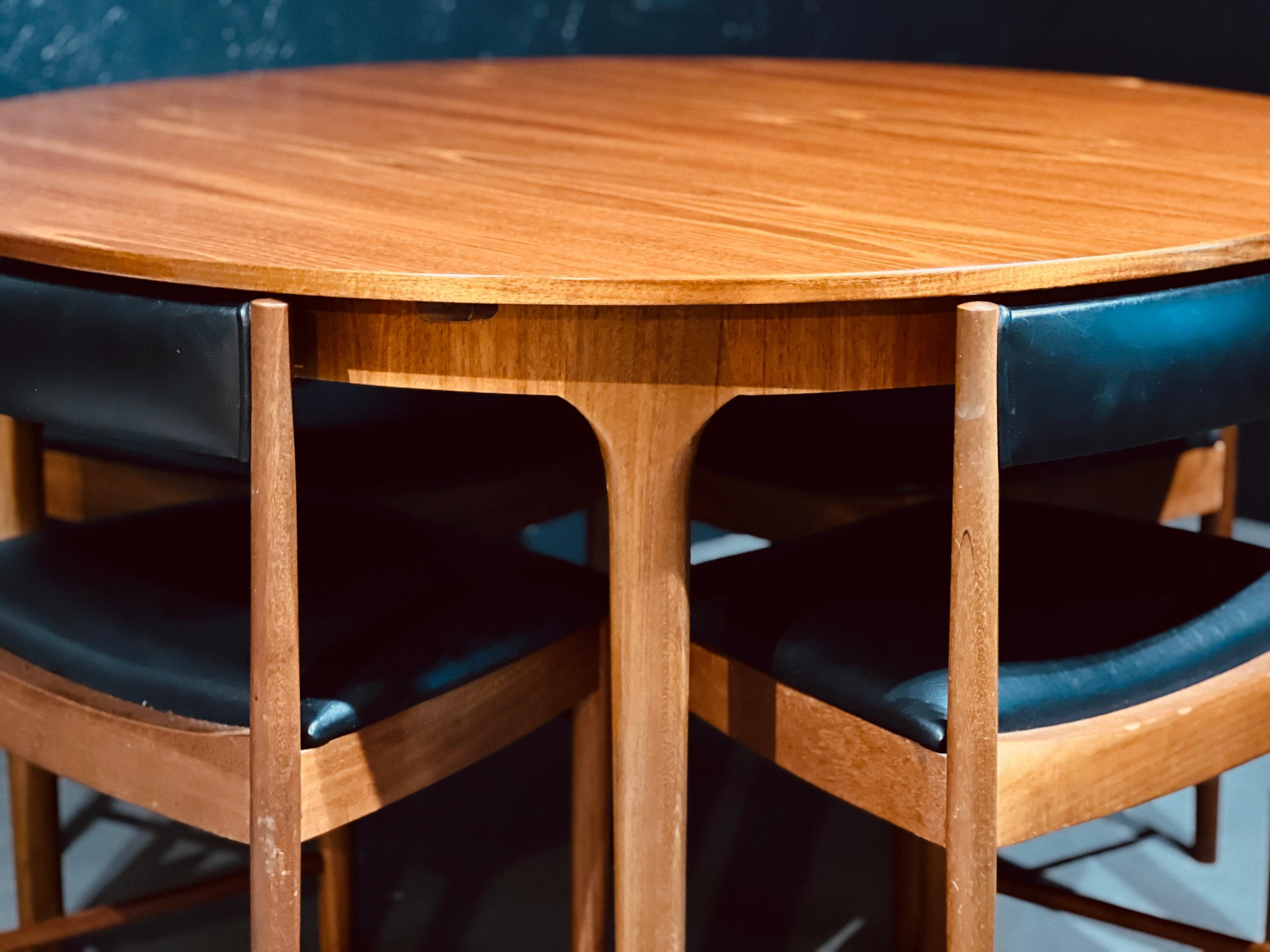 McIntosh Round Extending Teak Dining Table and Chairs in Black Vinyl In Excellent Condition In Buxton, GB